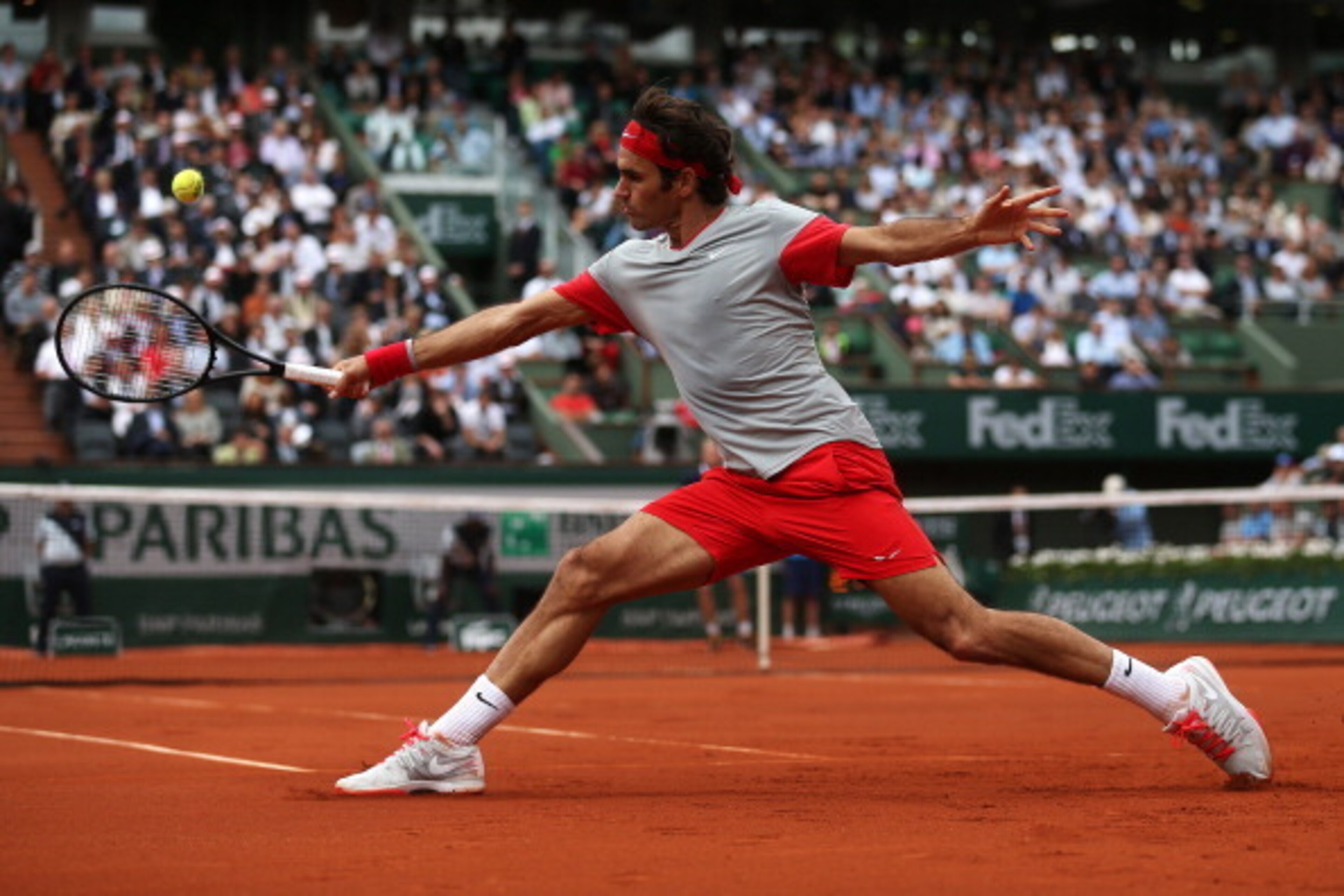 PARIS, FRANCE - MAY 30:  Roger Federer of Switzerland returns a shot during his men's singles match against Dmitry Tursunov of Russia on day six of the French Open at Roland Garros on May 30, 2014 in Paris, France.  (Photo by Matthew Stockman/Getty Images