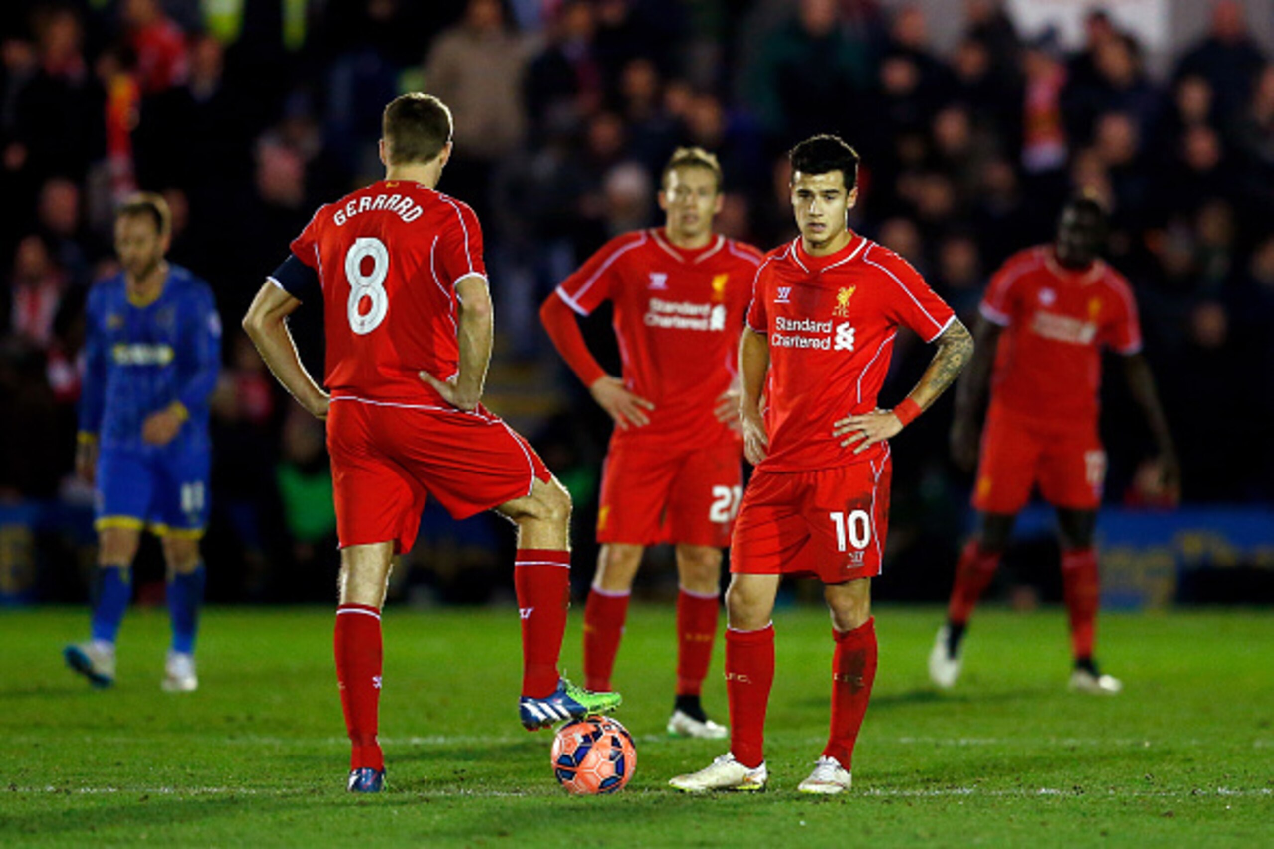 KINGSTON UPON THAMES, ENGLAND - JANUARY 05:  Shell shocked Liverpool players Steven Gerrard (L) and Philippe Coutinho (R) look on after Wimbledon score a goal to level the scores at 1-1 during the FA Cup Third Round match between AFC Wimbledon and Liverpo