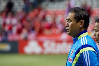VANCOUVER, BC - OCTOBER 28: Norio Sasaki Head Coach of Japan listens to the national anthems at the team bench prior to Women's International Soccer Friendly Series action against Canada on October 28, 2014 at BC Place Stadium in Vancouver, British Columb