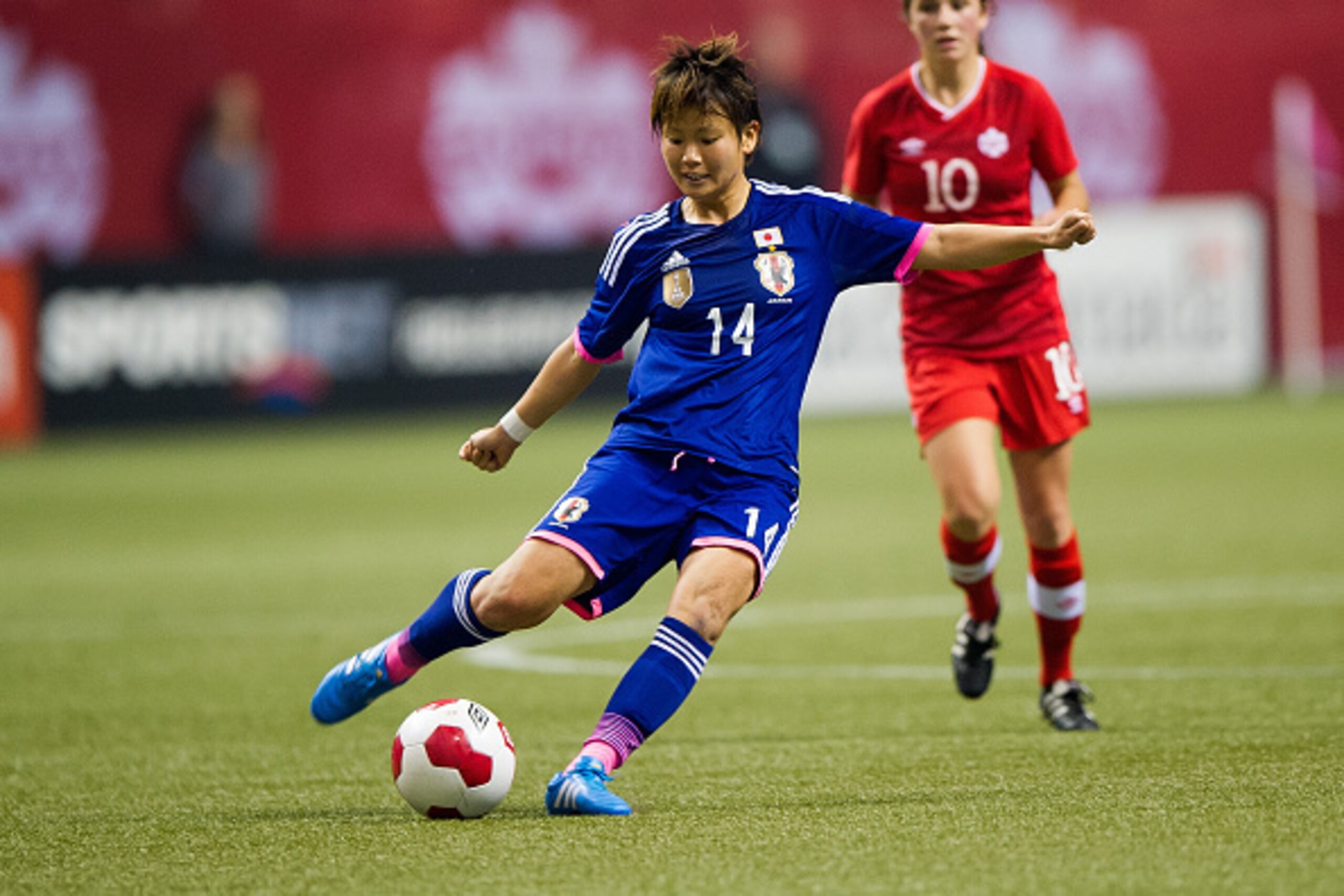 VANCOUVER, BC - OCTOBER 28: Asuna Tanaka #14 of Japan kicks the ball during Women's International Soccer Friendly Series action against Canada on October 28, 2014 at BC Place Stadium in Vancouver, British Columbia, Canada.  (Photo by Rich Lam/Getty Images