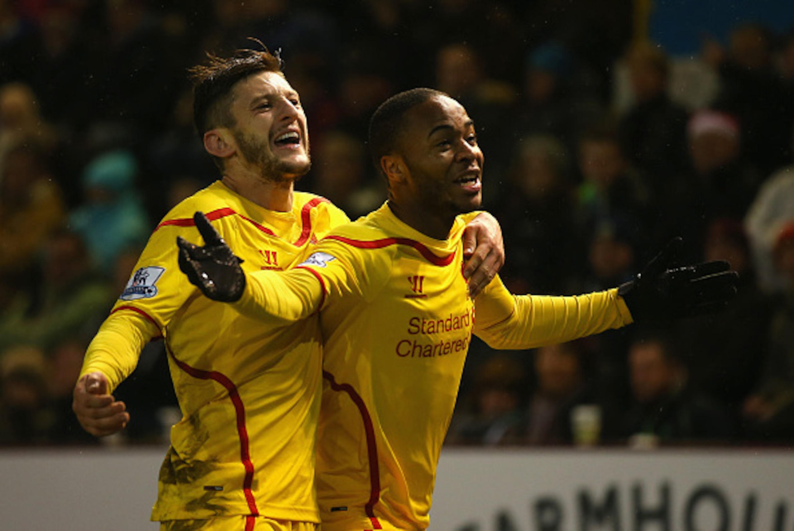 BURNLEY, ENGLAND - DECEMBER 26:  Raheem Sterling (R) of Liverpool celebrates scoring the opening goal with Adam Lallana during the Barclays Premier League match between Burnley and Liverpool at Turf Moor on December 26, 2014 in Burnley, England.  (Photo b