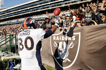 OAKLAND, CA - NOVEMBER 09:  Julius Thomas #80 of the Denver Broncos tosses the football to fans after his third-quarter touchdown against the Oakland Raiders at O.co Coliseum on November 9, 2014 in Oakland, California.  (Photo by Ezra Shaw/Getty Images)