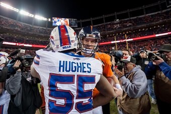 DENVER, CO - DECEMBER 7:  Quarterback Peyton Manning #18 of the Denver Broncos shakes hands with defensive end Jerry Hughes #55 of the Buffalo Bills after the Denver Broncos 24-17 win over the Buffalo Bills at Sports Authority Field at Mile High on Decemb