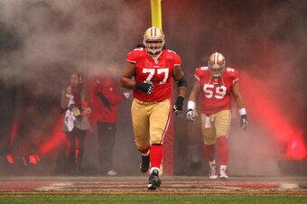 SAN FRANCISCO, CA - JANUARY 22:  Mike Iupati #77 of the San Francisco 49ers runs on the field during player introductions against the New York Giants during the NFC Championship Game at Candlestick Park on January 22, 2012 in San Francisco, California.  (