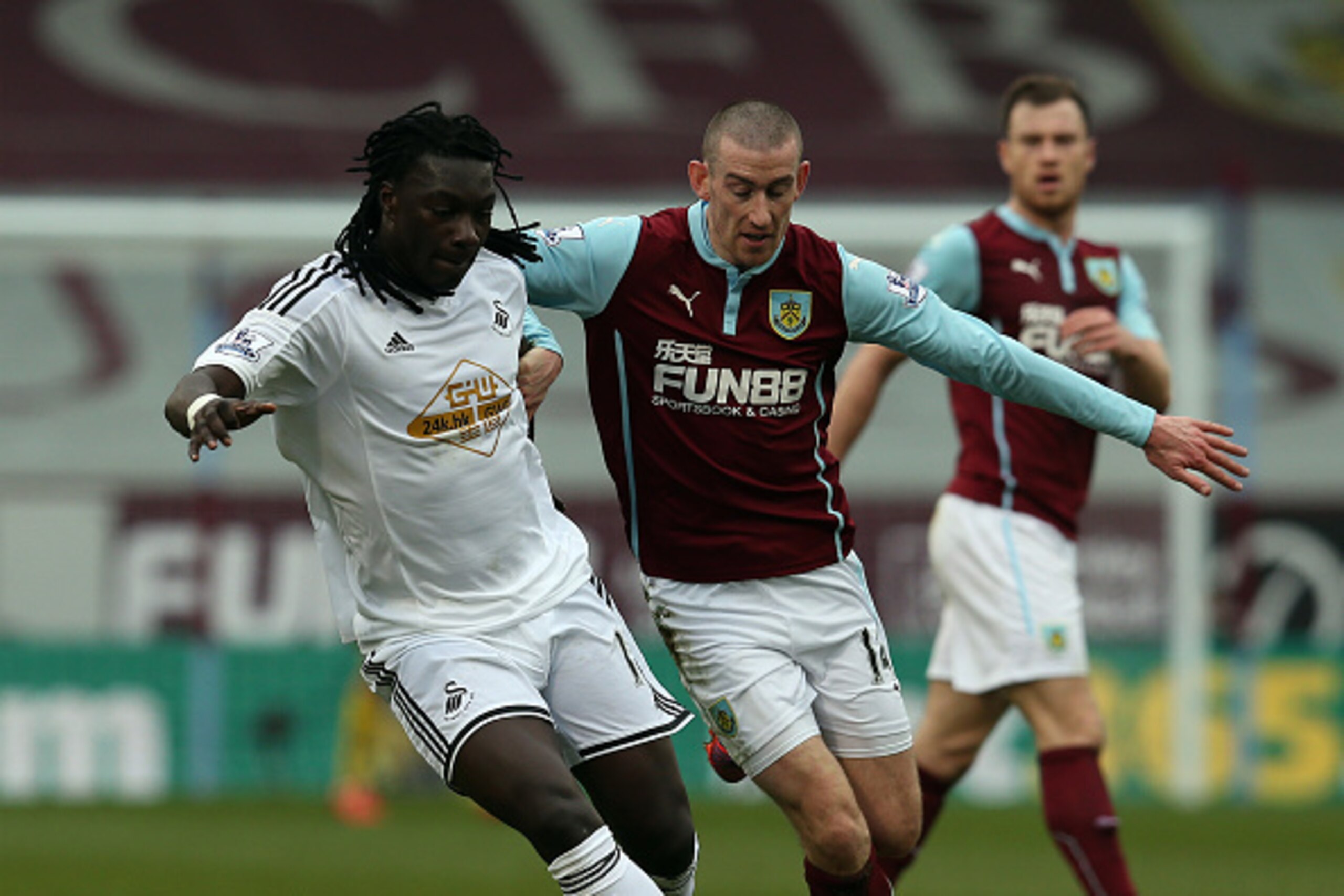 BURNLEY, ENGLAND - FEBRUARY 28: David Jones of Burnley in action with Bafitimbi Gomis of Swansea City during the Barclays Premier League match between Burnley and Swansea City at Turf Moor on February 28, 2015 in Burnley, England. (Photo by Chris Brunskil
