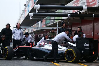 MONTMELO, SPAIN - FEBRUARY 21:  Jenson Button of Great Britain and McLaren Honda is pushed back into the garage during day three of Formula One Winter Testing at Circuit de Catalunya on February 21, 2015 in Montmelo, Spain.  (Photo by Dan Istitene/Getty I