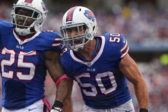 ORCHARD PARK, NY - OCTOBER 13: Kiko Alonso #50 of the Buffalo Bills and Da'Norris Searcy #25 celebrate after stopping  the Cincinnati Bengals during NFL game action at Ralph Wilson Stadium on October 13, 2013 in Orchard Park, New York. (Photo by Tom Szcze