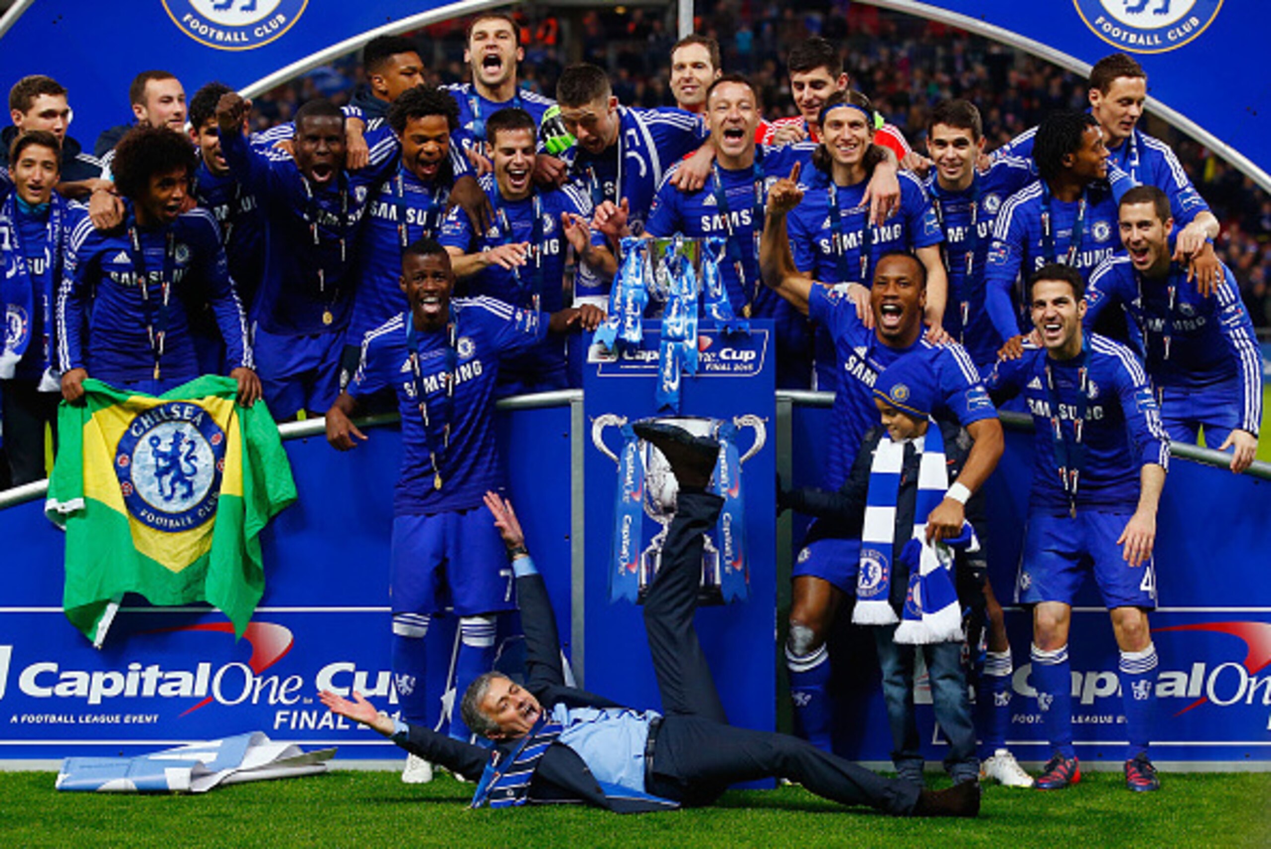 LONDON, ENGLAND - MARCH 01:  (EDITORS NOTE: ALTERNATIVE CROP OF IMAGE NUMBER #464882182) Manager Jose Mourinho of Chelsea lies on the pitch as Chelsea celebrate with the trophy during the Capital One Cup Final match between Chelsea and Tottenham Hotspur a