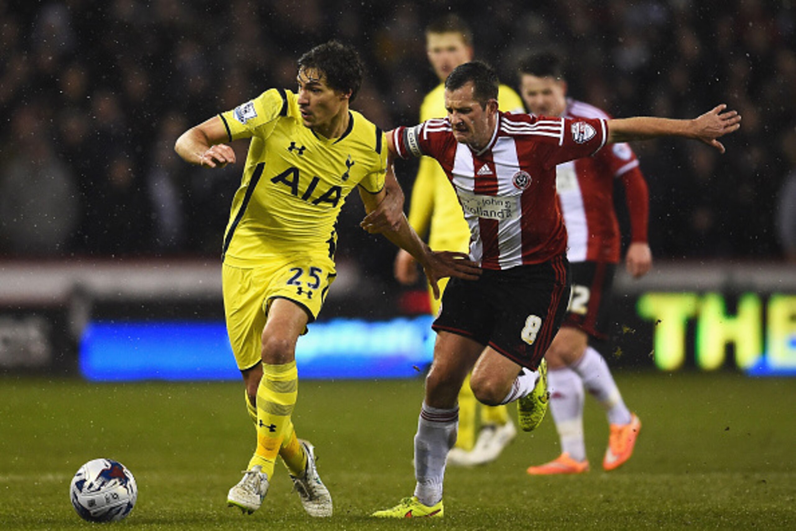 SHEFFIELD, ENGLAND - JANUARY 28: Benjamin Stambouli of Tottenham Hotspur is challenged by Michael Doyle of Sheffield United during the Capital One Cup Semi-Final Second Leg match between Sheffield United and Tottenham Hotspur at Bramall Lane on January 28