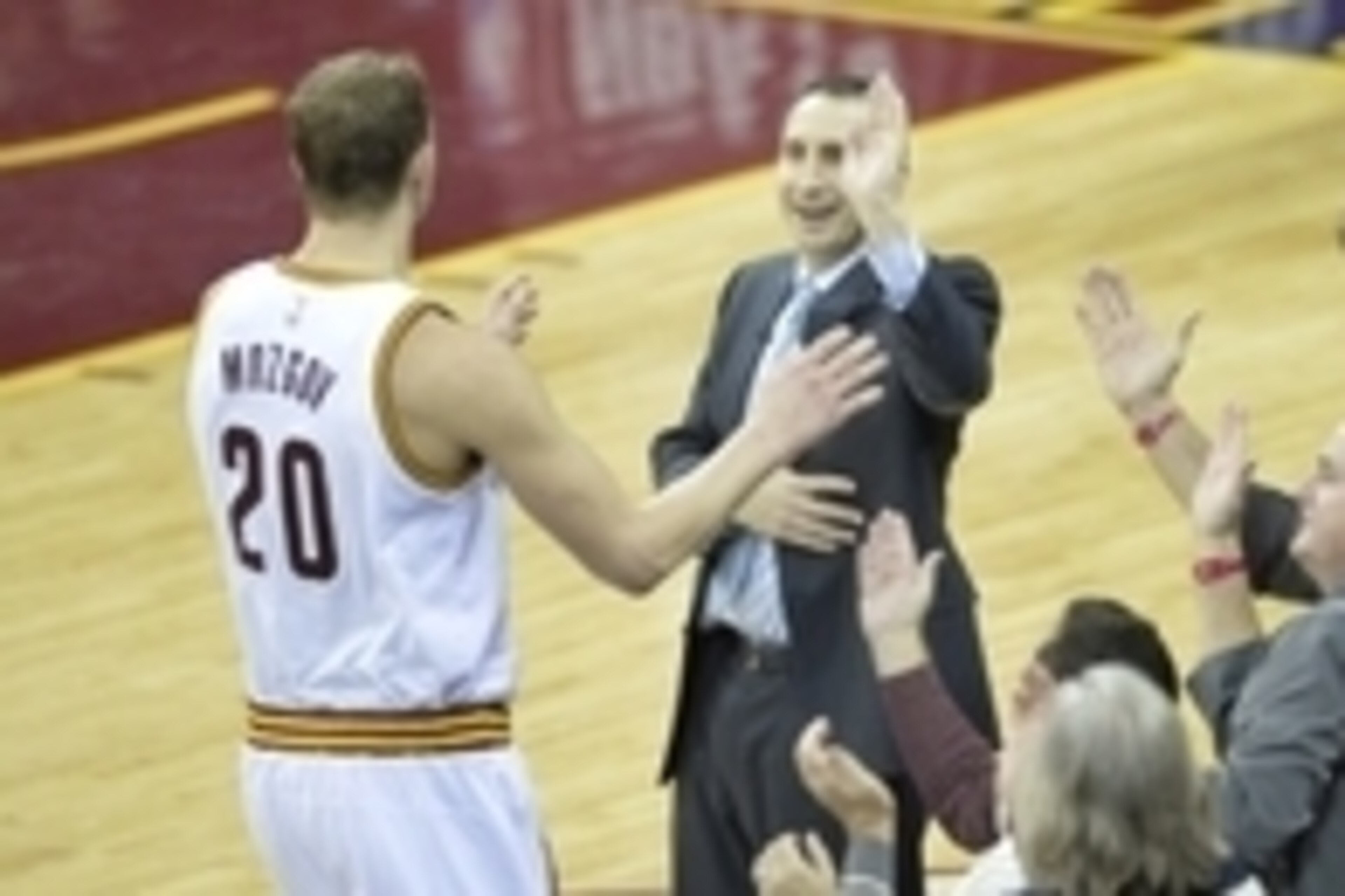 Feb 11, 2015; Cleveland, OH, USA; Cleveland Cavaliers head coach David Blatt celebrates with center Timofey Mozgov (20) in the fourth quarter against the Miami Heat at Quicken Loans Arena. Mandatory Credit: David Richard-USA TODAY Sports