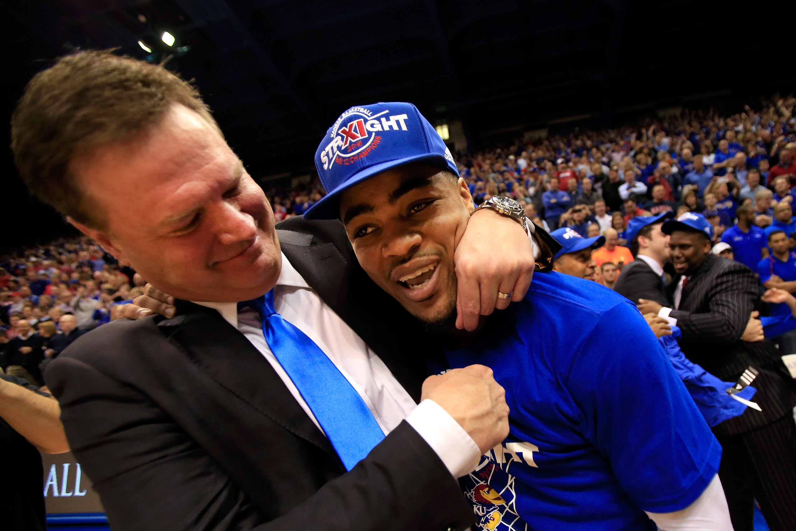 LAWRENCE, KS - MARCH 03:  Head coach Bill Self of the Kansas Jayhawks hugs Frank Mason III #0 after the Jayhawks defeated the West Virginia Mountaineers 76-69 in overtime to win the game and clinch their eleventh straight Big IX Championship title at Alle