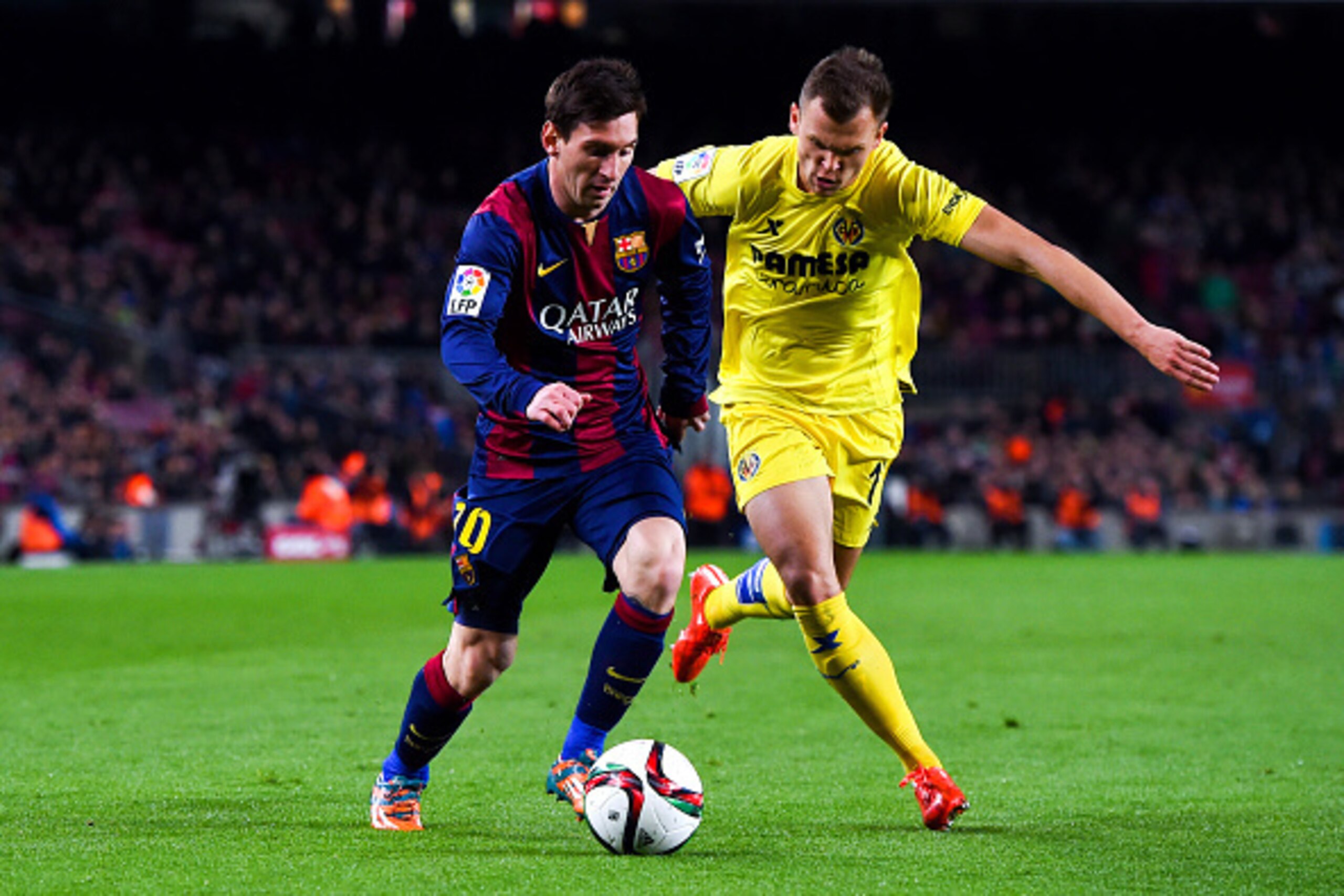 BARCELONA, SPAIN - FEBRUARY 11:  Lionel Messi of FC Barcelona competes for the ball with Denis Cheryshev of Villarreal CF during the Copa del Rey Semi-Final first leg match between FC Barcelona and Villarreal CF at Camp Nou on February 11, 2015 in Barcelo