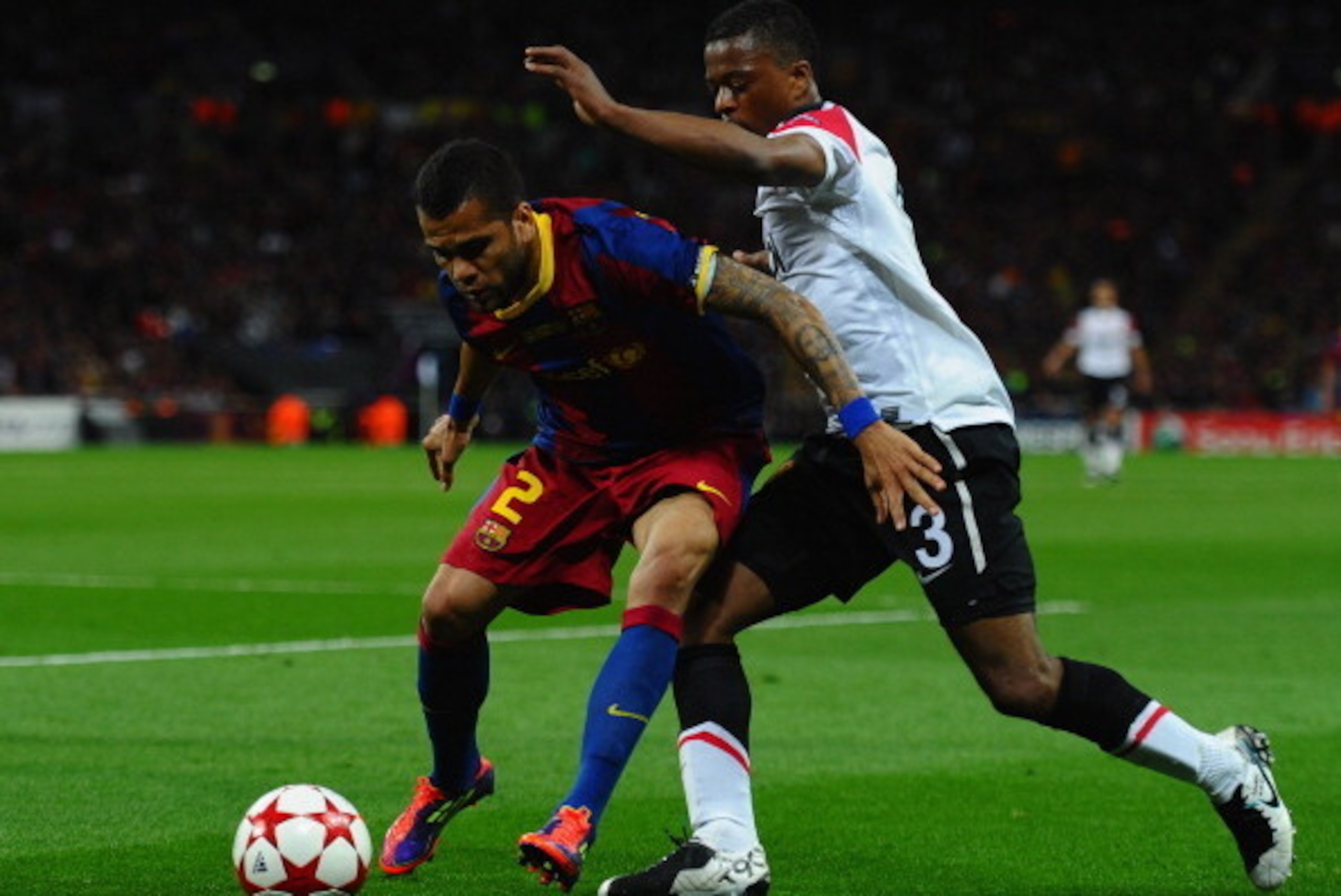 LONDON, ENGLAND - MAY 28:  Dani Alves of FC Barcelona holds off Patrice Evra of Manchester United during the UEFA Champions League final between FC Barcelona and Manchester United FC at Wembley Stadium on May 28, 2011 in London, England.  (Photo by Lauren