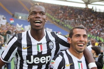 ROME, ITALY - MAY 11: Paul Labile Pogba with Carlos Tevez of Juventus celebrate the victory after the Serie A match between AS Roma and Juventus at Stadio Olimpico on May 11, 2014 in Rome, Italy.  (Photo by Paolo Bruno/Getty Images)