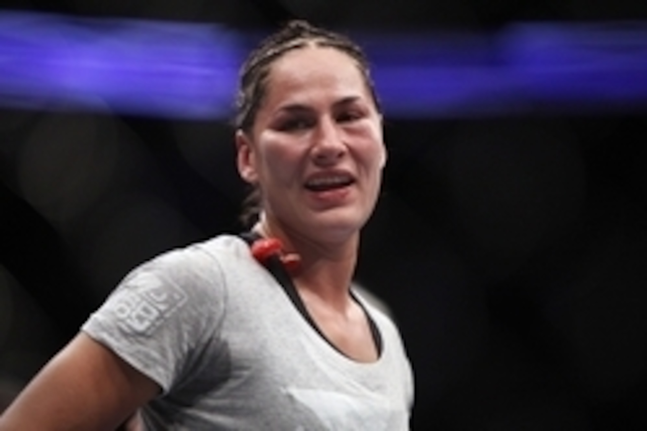Oct 19, 2013; Houston, TX, USA; Jessica Eye (blue gloves) reacts after being defeated by decision by Sarah Kaufman (not pictured) in their women's bantamweight bout during UFC 166 at Toyota Center. Mandatory Credit: Andrew Richardson-USA TODAY Sports
