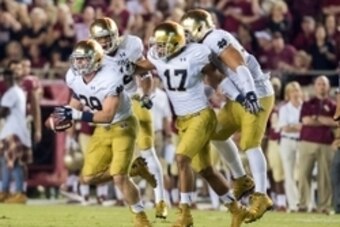 Oct 18, 2014; Tallahassee, FL, USA; Notre Dame Fighting Irish linebacker Joe Schmidt (38) and linebacker James Onwualu (17) celebrate after an interception in the second quarter against the Florida State Seminoles at Doak Campbell Stadium. Mandatory Credi