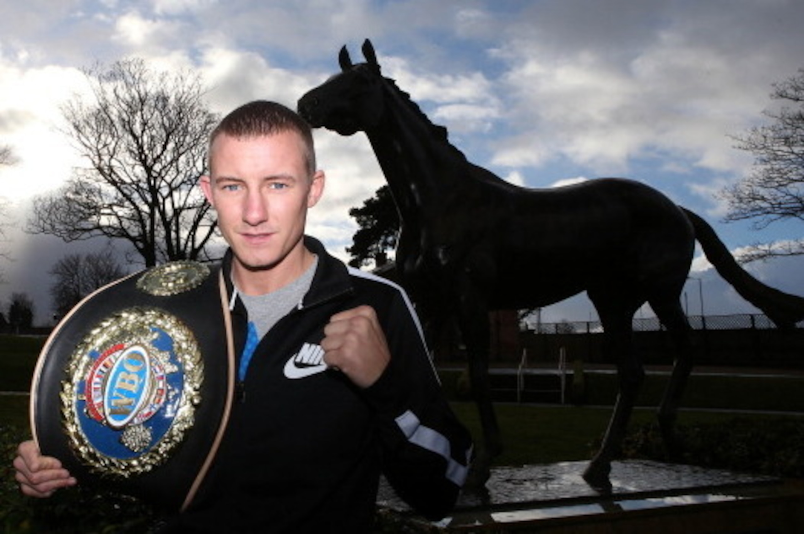 LIVERPOOL, ENGLAND - JANUARY 9:   Paul Butler poses at a statue of Red Rum during a press conference at Aintree Racecourse on January 9, 2014 in Liverpool, England.  (Photo by Jan Kruger/Getty Images)