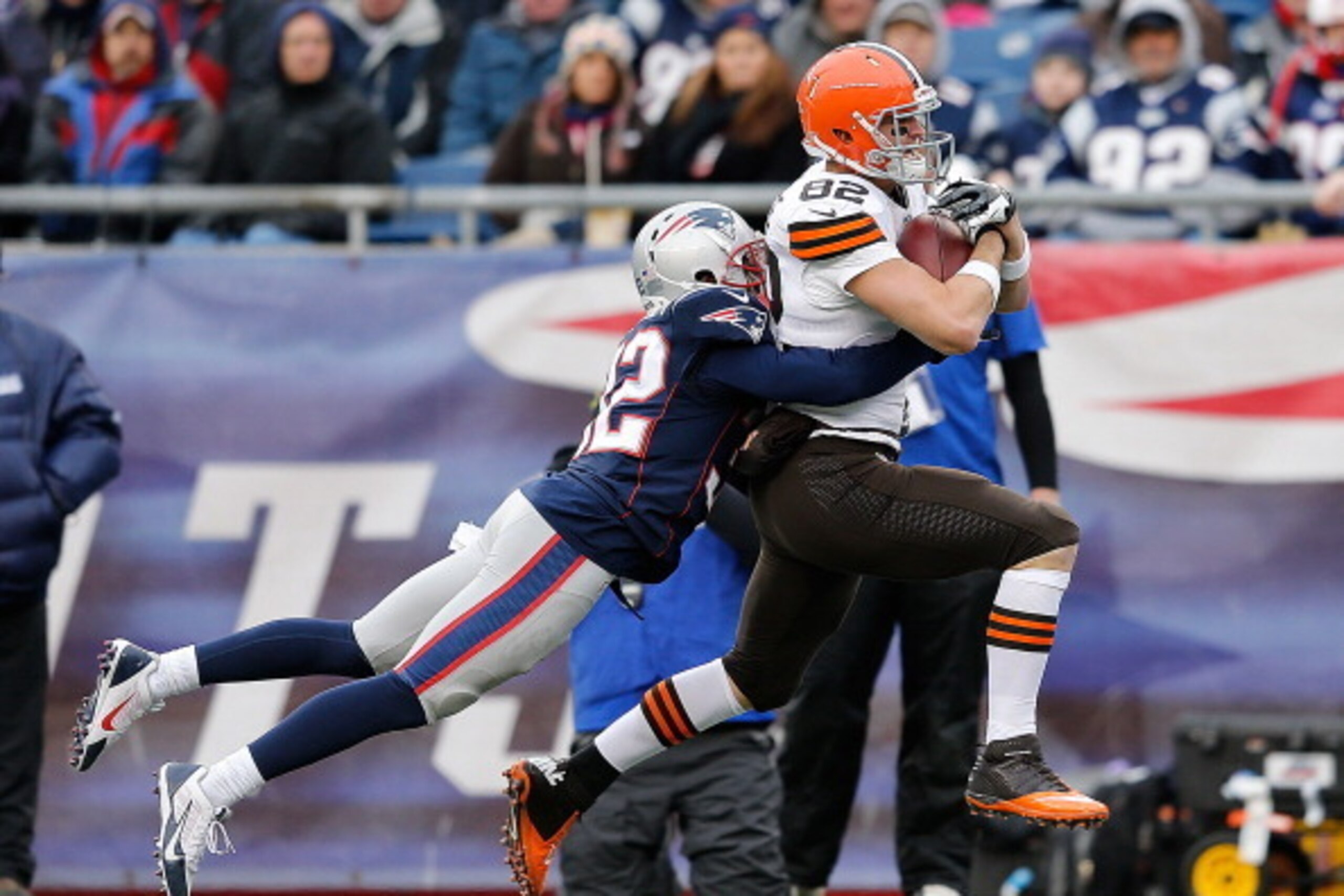 FOXBORO, MA - DECEMBER 8:  Gary Barnidge #82 of the Cleveland Browns runs the ball as Devin McCourty #32 of the New England Patriots defends against the New England Patriots  at Gillette Stadium on December 8, 2013 in Foxboro, Massachusetts. (Photo by Jim