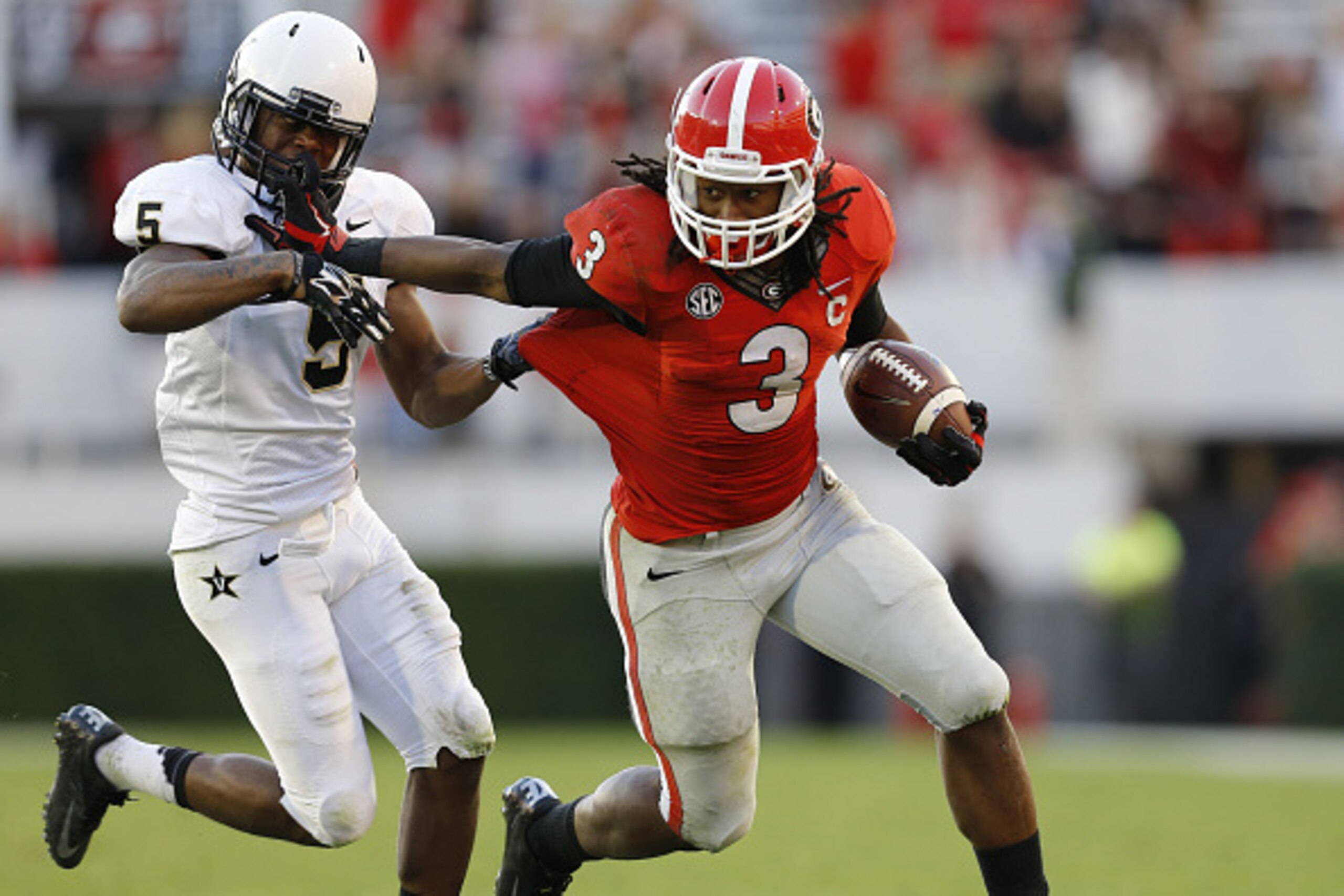 ATHENS, GA - OCTOBER 04:  Running back Todd Gurley #3 of the Georgia Bulldogs stiff arms cornerback Torren McGaster #5 of the Vanderbilt Commodores during a running play in the game at Sanford Stadium on October 4, 2014 in Athens, Georgia.  (Photo by Mike