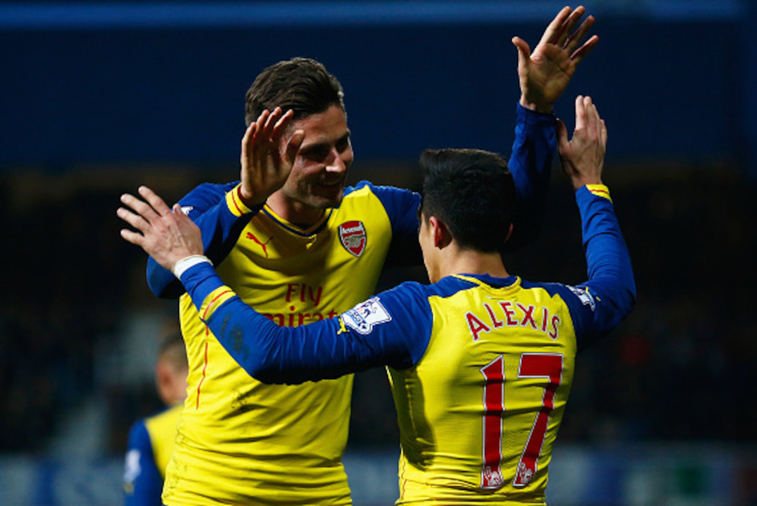 LONDON, ENGLAND - MARCH 04:  Alexis Sanchez of Arsenal (17) celebrates with Olivier Giroud as he scores their second goal during the Barclays Premier League match between Queens Park Rangers and Arsenal at Loftus Road on March 4, 2015 in London, England. 