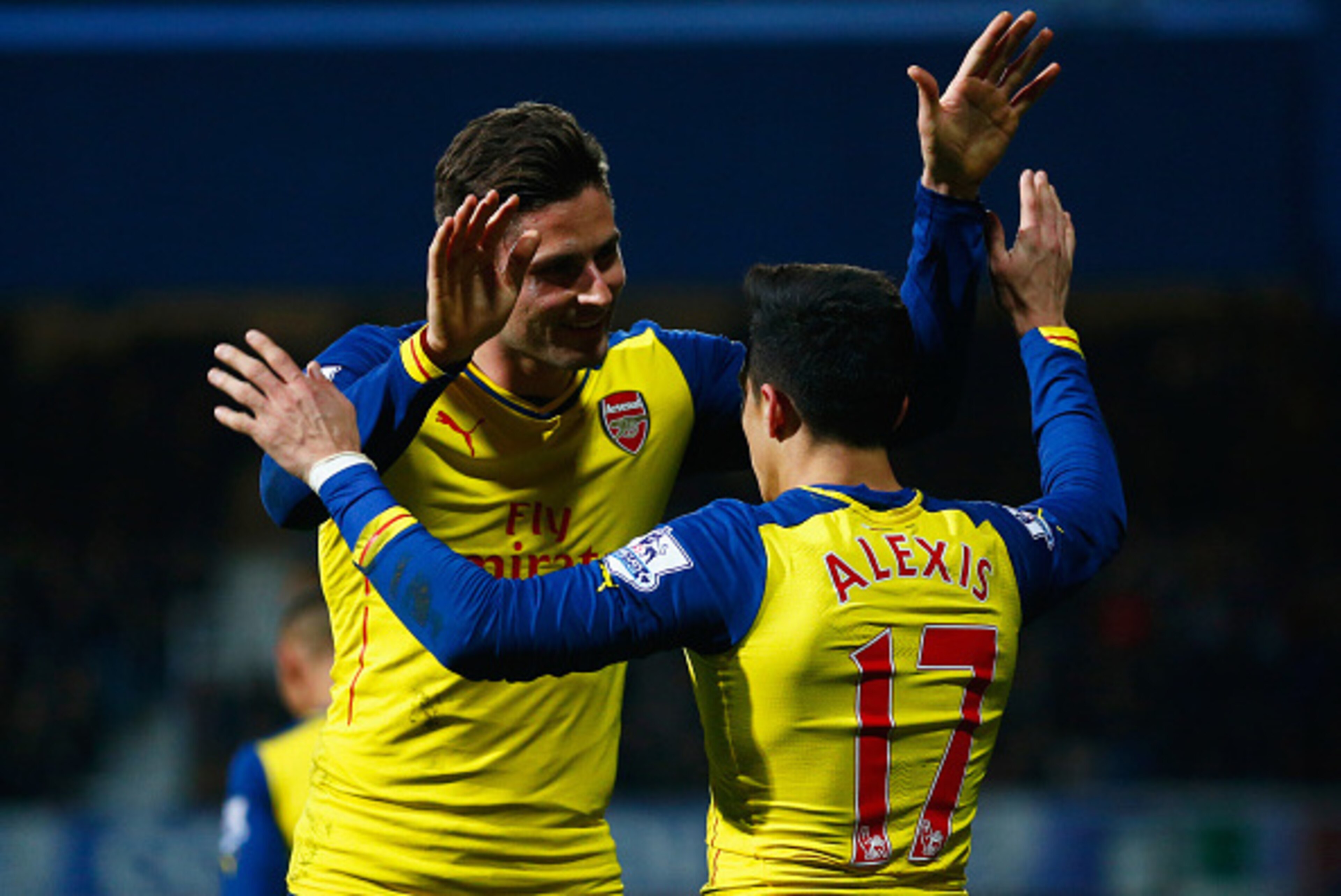 LONDON, ENGLAND - MARCH 04:  Alexis Sanchez of Arsenal (17) celebrates with Olivier Giroud as he scores their second goal during the Barclays Premier League match between Queens Park Rangers and Arsenal at Loftus Road on March 4, 2015 in London, England. 