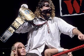Mankind (Mick Foley) celebrates winning the WWE title.