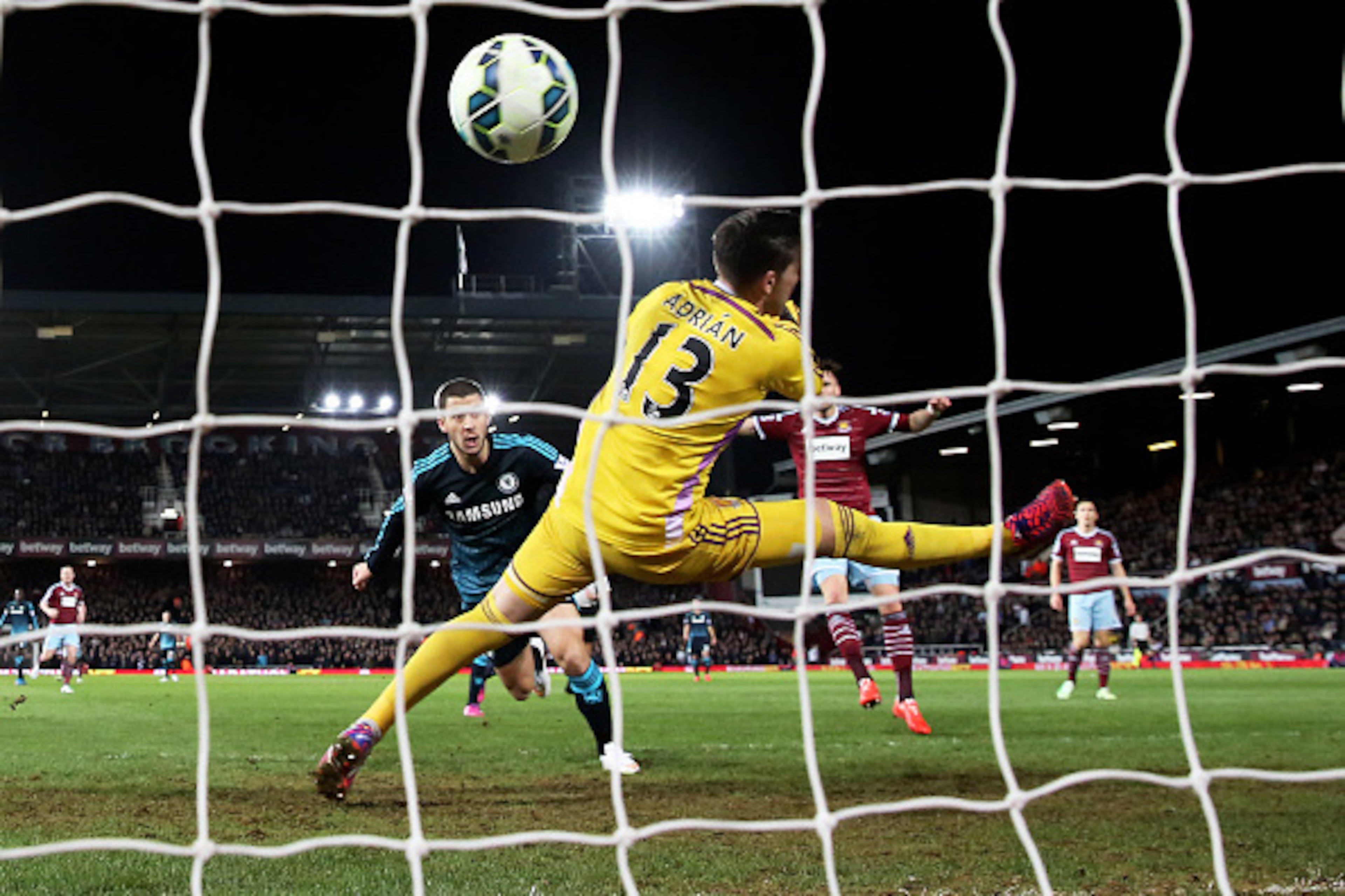 LONDON, ENGLAND - MARCH 04:  Eden Hazard of Chelsea scores the opening goal by heading the ball past goalkeeper Adrian of West Ham during the Barclays Premier League match between West Ham and Chelsea at the Boleyn Ground on March 4, 2015 in London, Engla