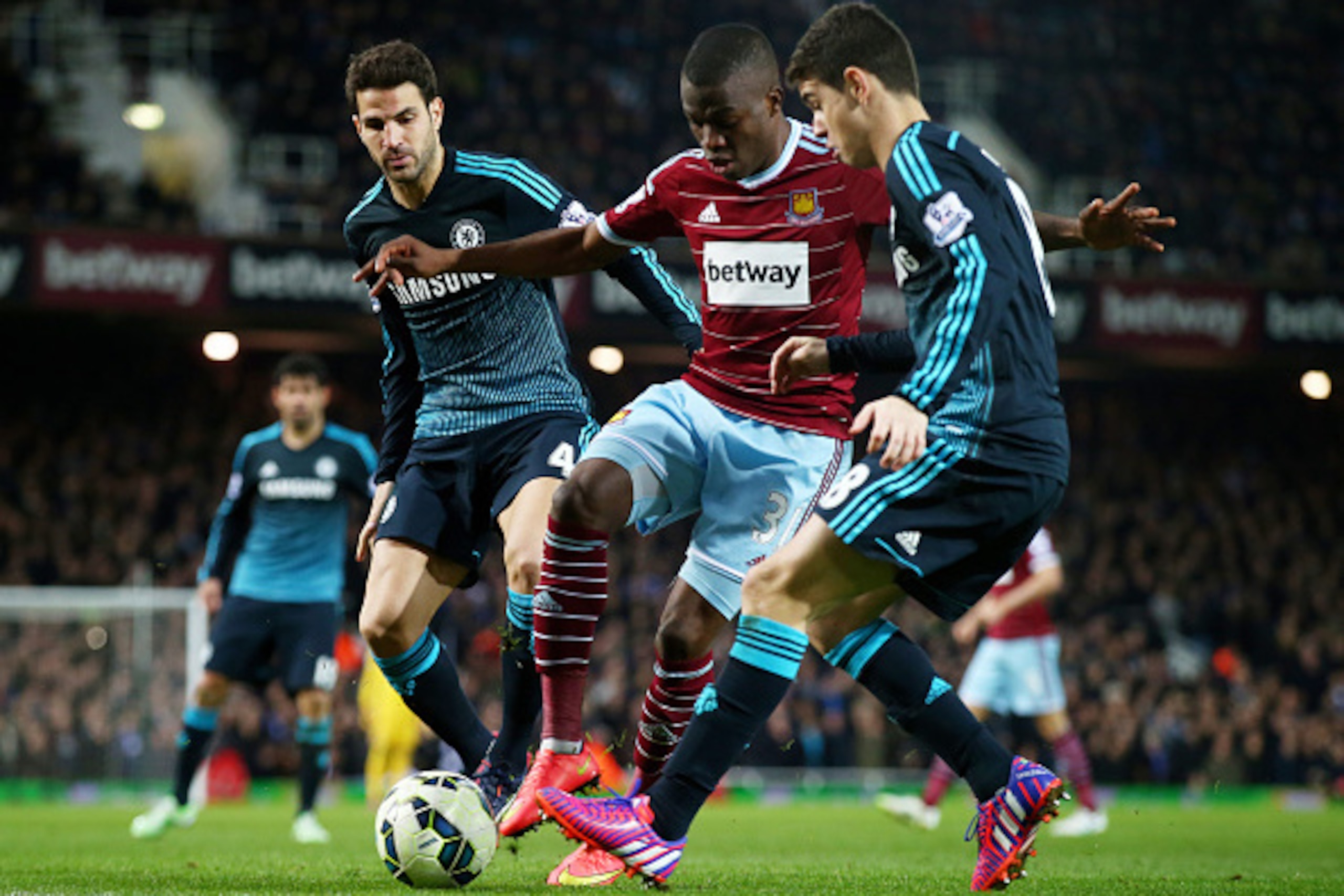 LONDON, ENGLAND - MARCH 04:  Enner Valencia of West Ham is closed down by Cesc Fabregas of Chelsea and Oscar of Chelsea during the Barclays Premier League match between West Ham and Chelsea at the Boleyn Ground on March 4, 2015 in London, England.  (Photo