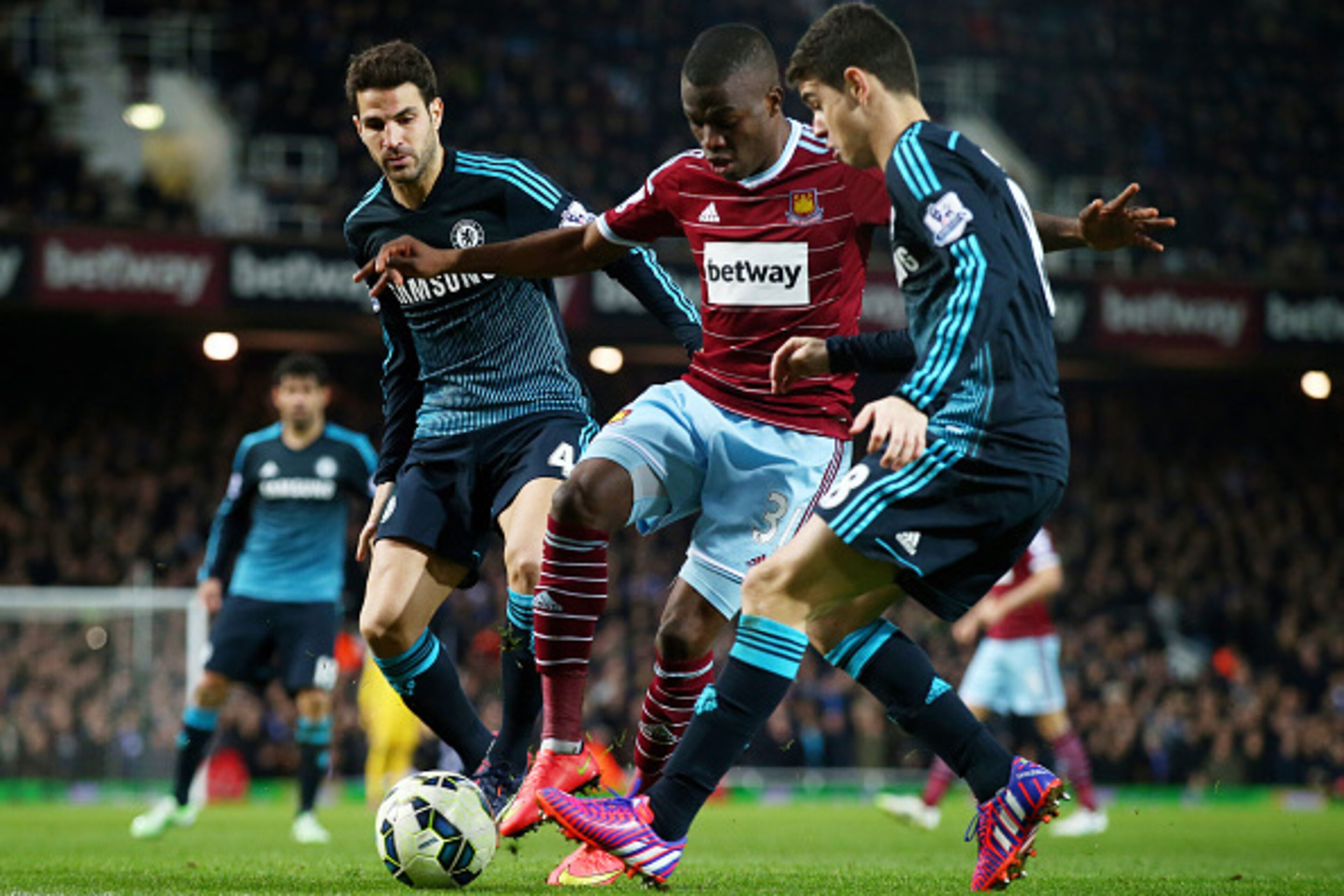 LONDON, ENGLAND - MARCH 04:  Enner Valencia of West Ham is closed down by Cesc Fabregas of Chelsea and Oscar of Chelsea during the Barclays Premier League match between West Ham and Chelsea at the Boleyn Ground on March 4, 2015 in London, England.  (Photo