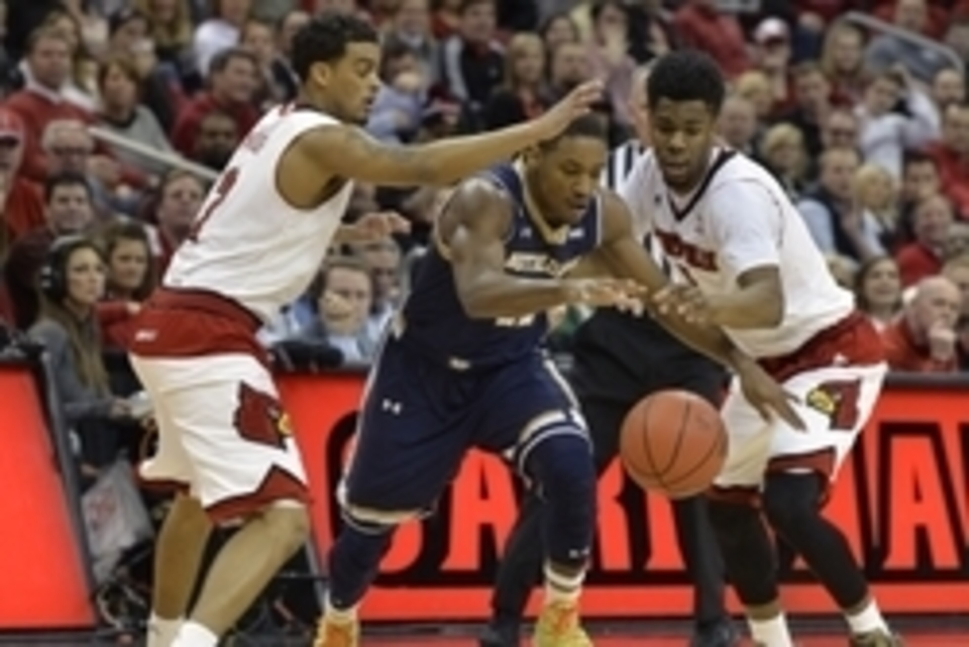 Mar 4, 2015; Louisville, KY, USA; Notre Dame Fighting Irish guard Demetrius Jackson (11) scrambles for a loose ball under the pressure of Louisville Cardinals guard Quentin Snider (2) and guard Anton Gill (1) during the first half at KFC Yum! Center. Notr