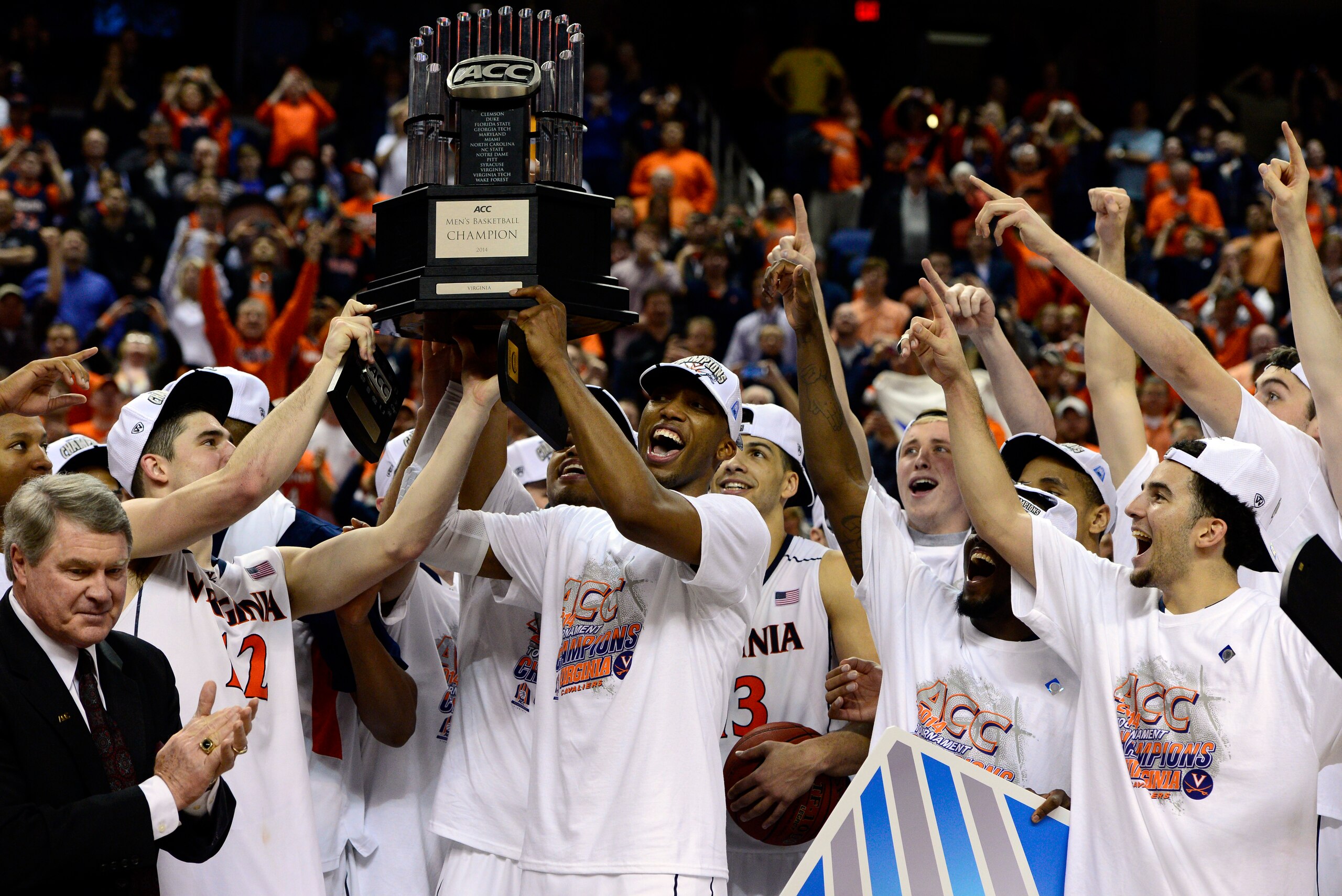 Mar 16, 2014; Greensboro, NC, USA; The Virginia Cavaliers celebrate their 72-63 victory over the Duke Blue Devils in the championship game of the ACC college basketball tournament at Greensboro Coliseum. Mandatory Credit: John David Mercer-USA TODAY Sport