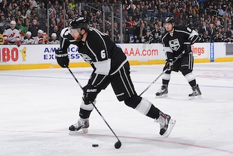 LOS ANGELES, CA - JANUARY 14: Jake Muzzin #6 of the Los Angeles Kings prepares to pass the puck as Drew Doughty #8 of the Los Angeles Kings looks on at STAPLES Center on January 14, 2015 in Los Angeles, California. (Photo by Juan Ocampo/NHLI via Getty Ima