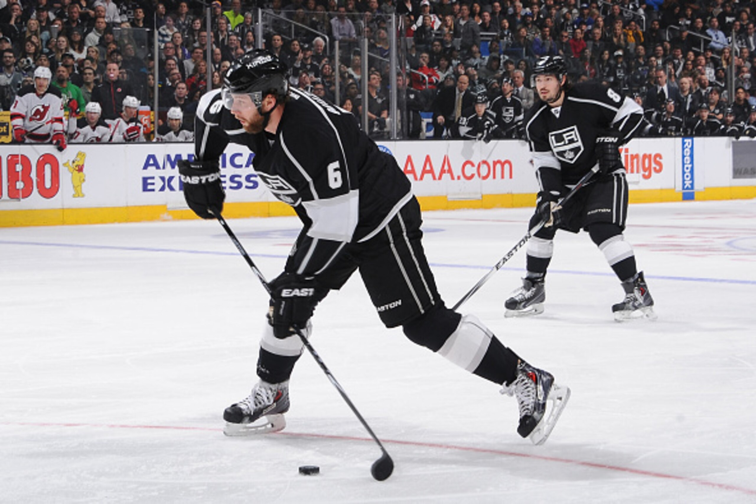 LOS ANGELES, CA - JANUARY 14: Jake Muzzin #6 of the Los Angeles Kings prepares to pass the puck as Drew Doughty #8 of the Los Angeles Kings looks on at STAPLES Center on January 14, 2015 in Los Angeles, California. (Photo by Juan Ocampo/NHLI via Getty Ima