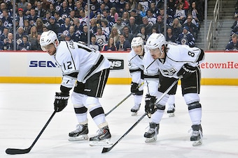 WINNIPEG, CANADA - MARCH 1: Marian Gaborik #12, Dustin Brown #23 and Drew Doughty #8 of the Los Angeles Kings get set during a first period face-off against the Winnipeg Jets on March 1, 2015 at the MTS Centre in Winnipeg, Manitoba, Canada.  (Photo by Lan