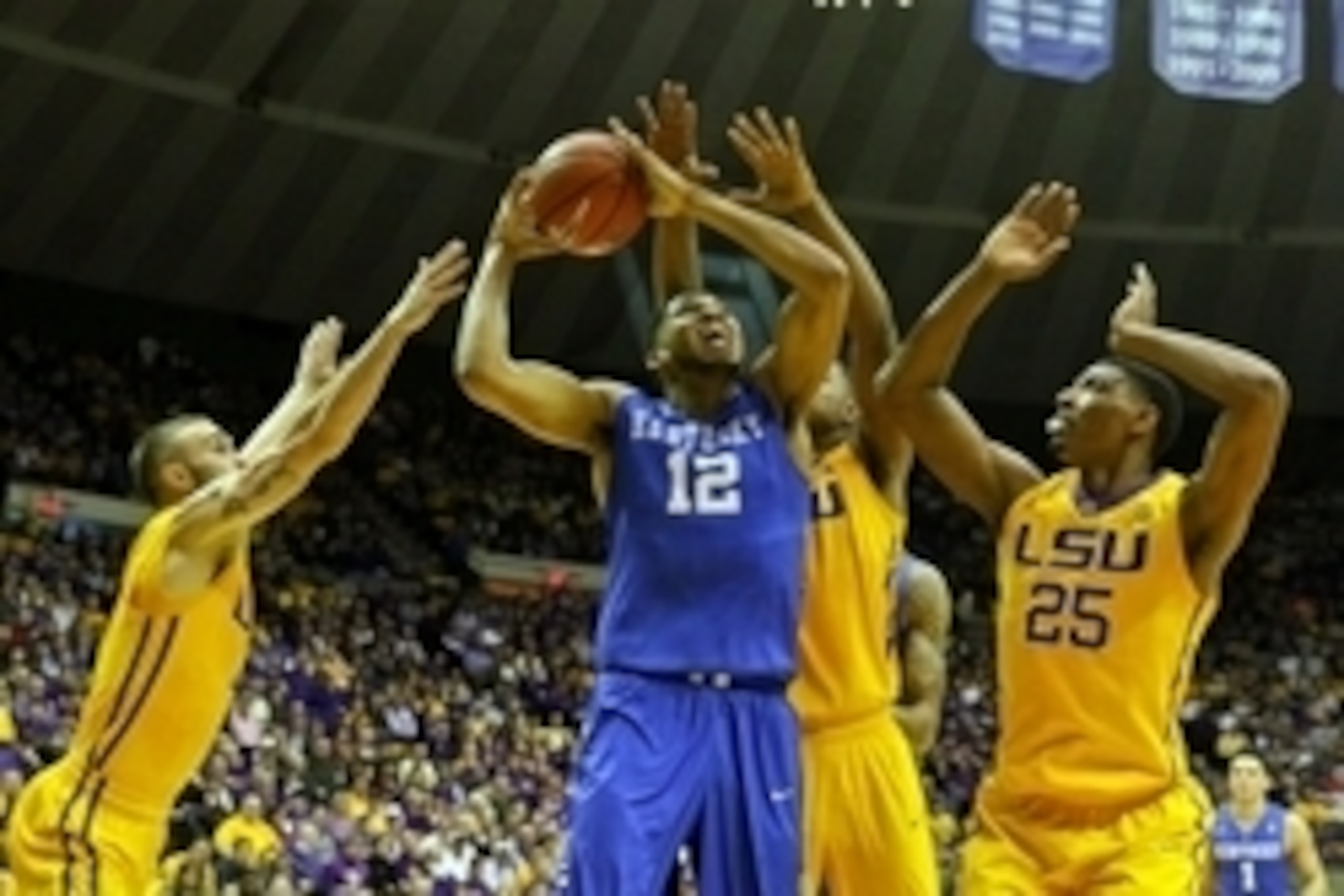 Feb 10, 2015; Baton Rouge, LA, USA; Kentucky Wildcats forward Karl-Anthony Towns (12) is defended by LSU Tigers guard Keith Hornsby (4) and forward Jarell Martin (1) and forward Jordan Mickey (25) during the first half of a game at the Pete Maravich Assem