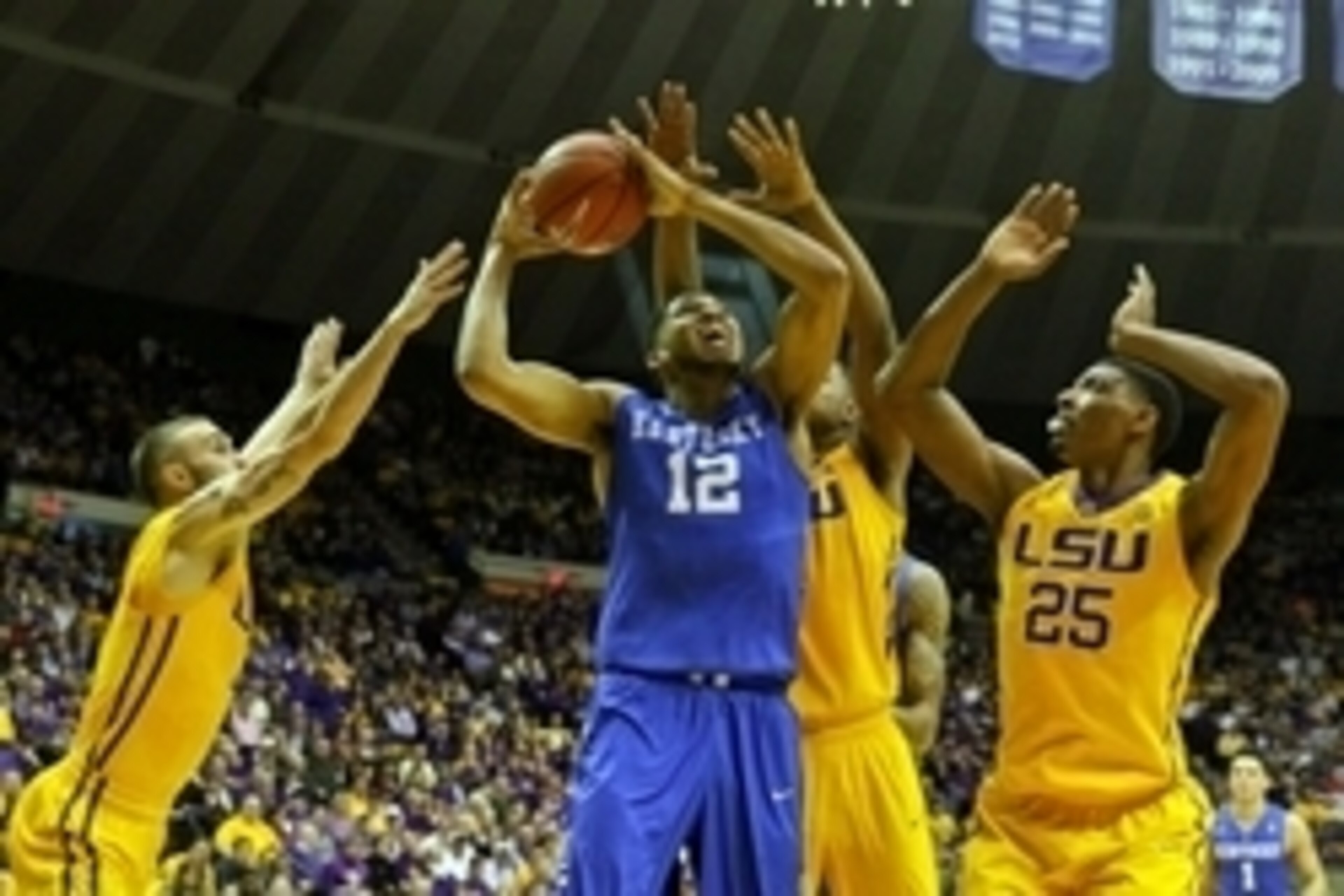 Feb 10, 2015; Baton Rouge, LA, USA; Kentucky Wildcats forward Karl-Anthony Towns (12) is defended by LSU Tigers guard Keith Hornsby (4) and forward Jarell Martin (1) and forward Jordan Mickey (25) during the first half of a game at the Pete Maravich Assem
