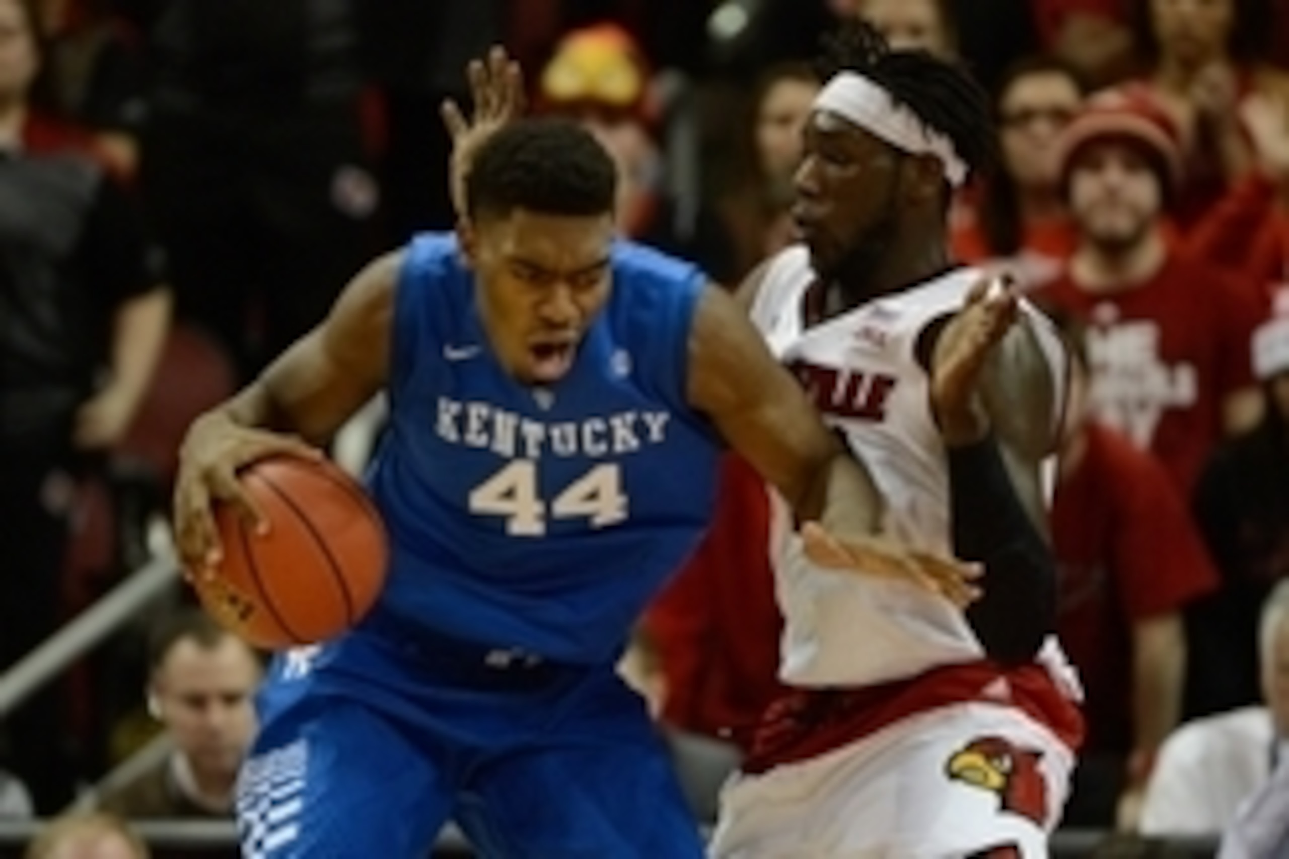 Dec 27, 2014; Louisville, KY, USA; Kentucky Wildcats center Dakari Johnson (44) posts up against Louisville Cardinals forward Montrezl Harrell (24) during the second half at KFC Yum! Center. Kentucky defeated Louisville 58-50.  Mandatory Credit: Jamie Rho