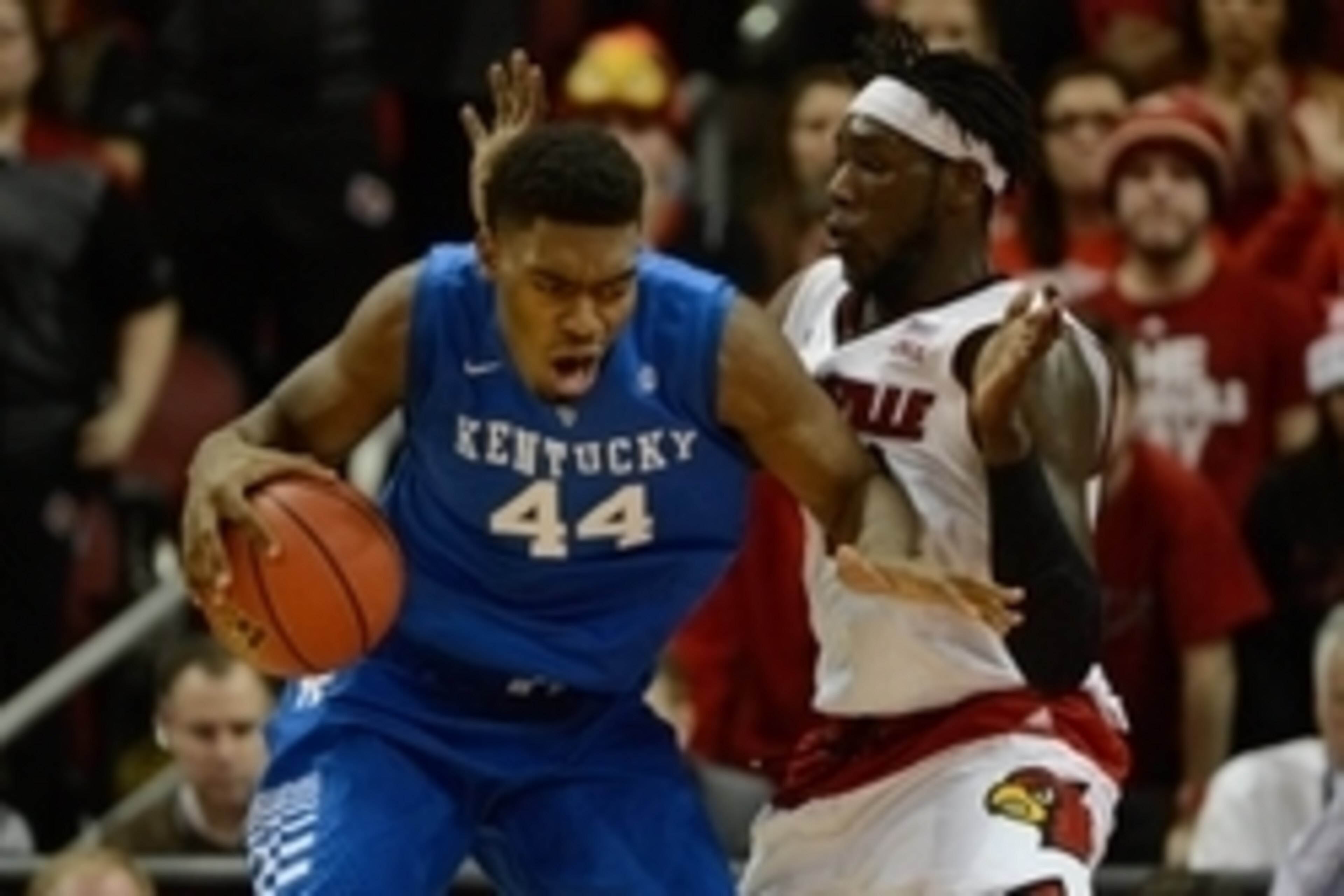 Dec 27, 2014; Louisville, KY, USA; Kentucky Wildcats center Dakari Johnson (44) posts up against Louisville Cardinals forward Montrezl Harrell (24) during the second half at KFC Yum! Center. Kentucky defeated Louisville 58-50.  Mandatory Credit: Jamie Rho