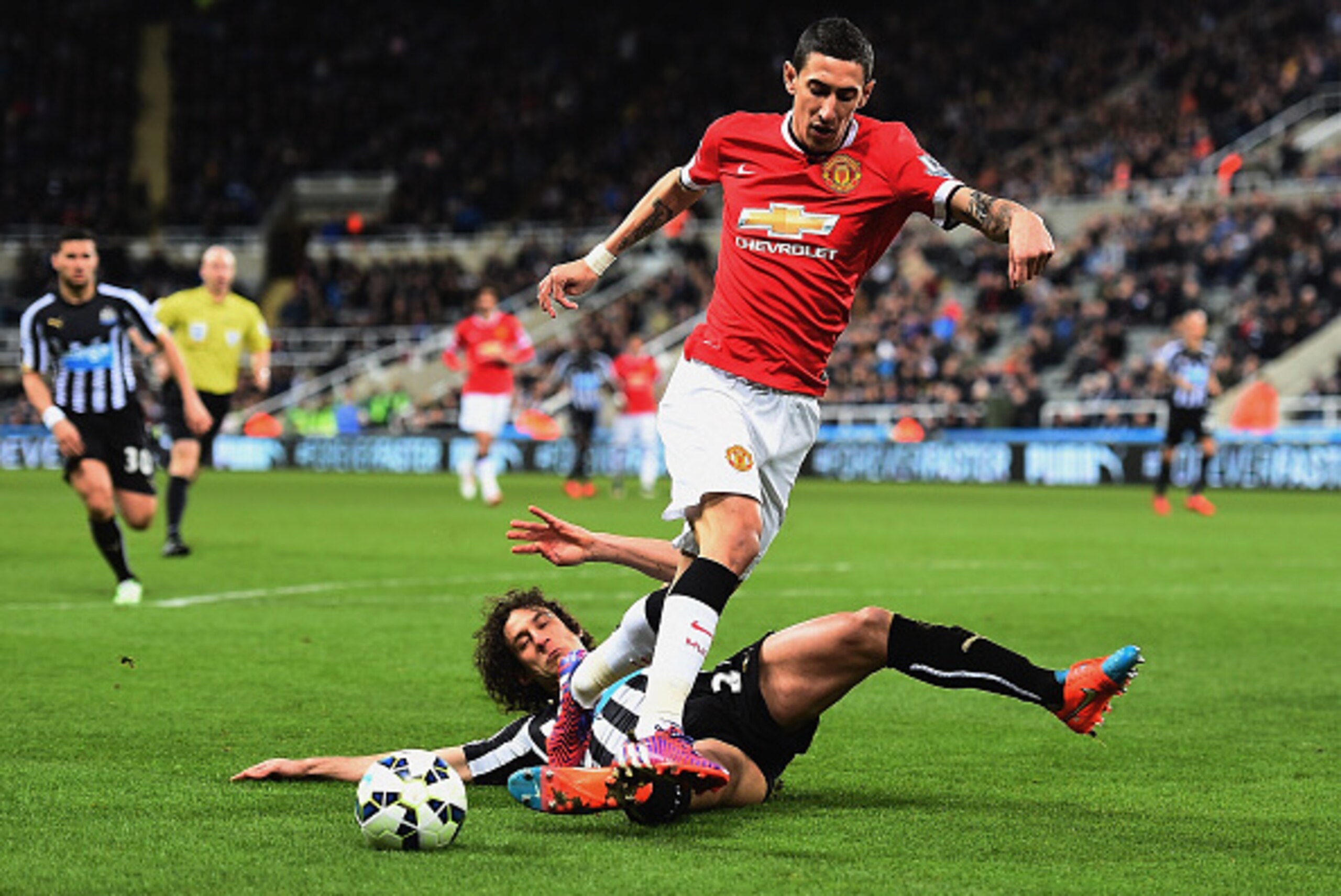 NEWCASTLE UPON TYNE, ENGLAND - MARCH 04: Fabricio Coloccini of Newcastle United tackles Angel di Maria of Manchester United  during the Barclays Premier League match between Newcastle United and Manchester United at St James' Park on March 4, 2015 in Newc