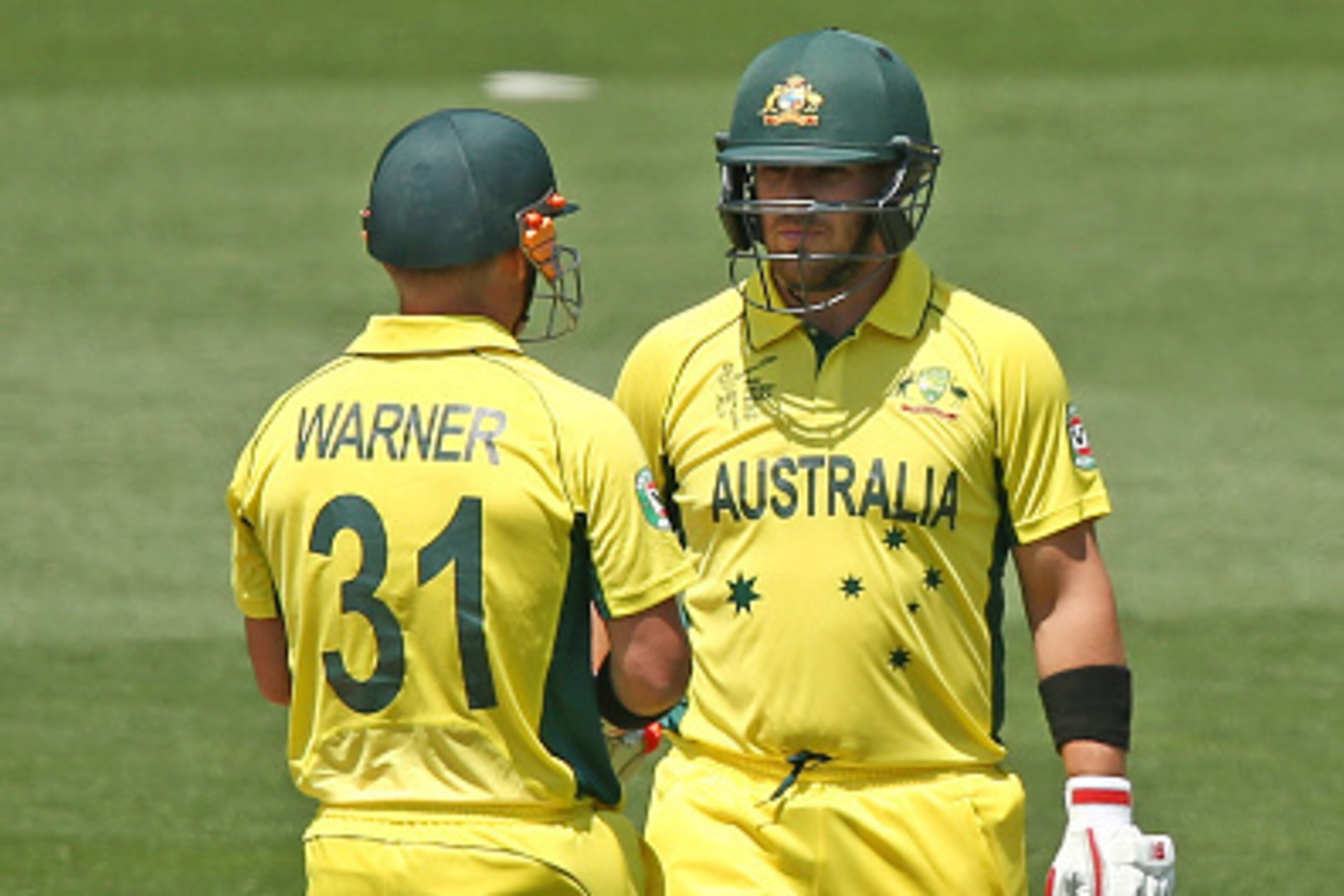 ADELAIDE, AUSTRALIA - FEBRUARY 08: David Warner and Aaron Finch of Australia speak between overs during the ICC Cricket World Cup warm up match between Australia and India at Adelaide Oval on February 8, 2015 in Adelaide, Australia.  (Photo by Morne de Kl