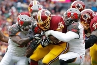Nov 16, 2014; Landover, MD, USA; Washington Redskins running back Alfred Morris (46) is tackled by Tampa Bay Buccaneers free safety Major Wright (31), Buccaneers running back Charles Sims (34), and Buccaneers defensive end Larry English (57) at FedEx Fiel
