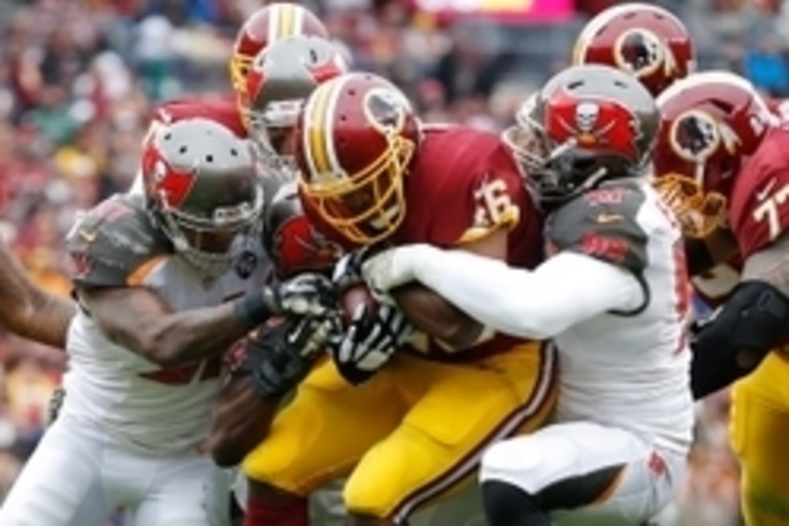Nov 16, 2014; Landover, MD, USA; Washington Redskins running back Alfred Morris (46) is tackled by Tampa Bay Buccaneers free safety Major Wright (31), Buccaneers running back Charles Sims (34), and Buccaneers defensive end Larry English (57) at FedEx Fiel