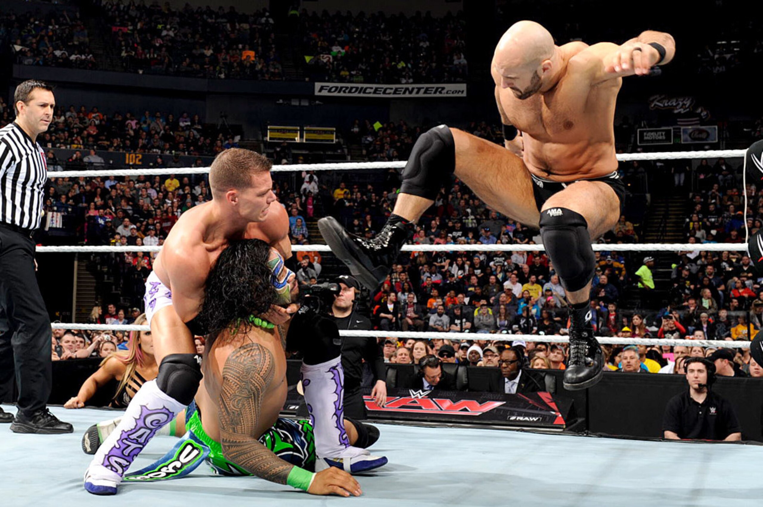 Tyson Kidd and Cesaro attack Jimmy Uso.
