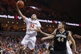Feb 14, 2015; Charlottesville, VA, USA; Virginia Cavaliers guard London Perrantes (32) shoots the ball as Wake Forest Demon Deacons forward Konstantinos Mitoglou (44) looks on in the second half at John Paul Jones Arena. The Cavaliers won 61-60. Mandatory
