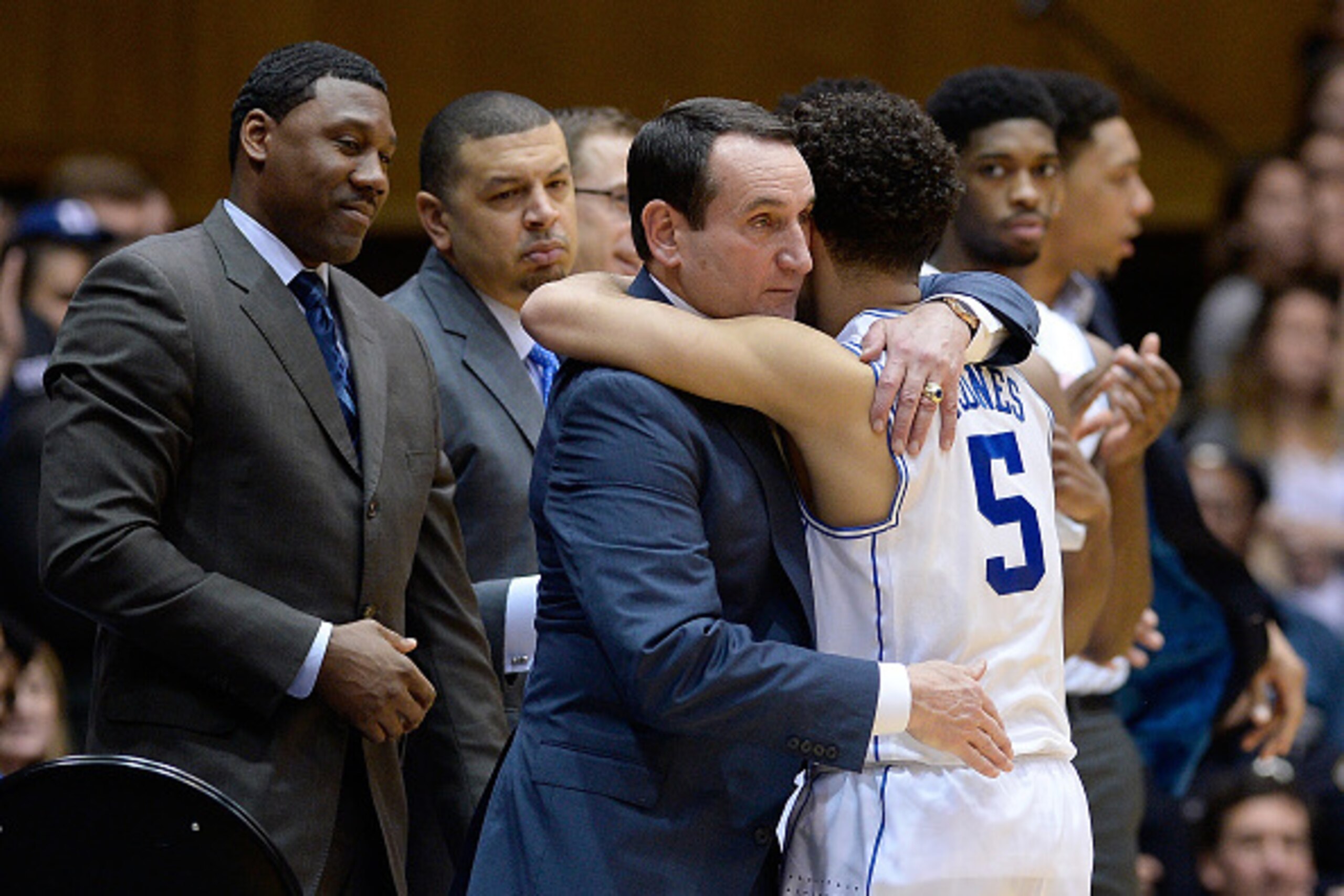 DURHAM, NC - FEBRUARY 21:  Head coach Mike Krzyzewski embraces Tyus Jones #5 of the Duke Blue Devils during the final seconds of their win against the Clemson Tigers at Cameron Indoor Stadium on February 21, 2015 in Durham, North Carolina. Duke won 78-56.