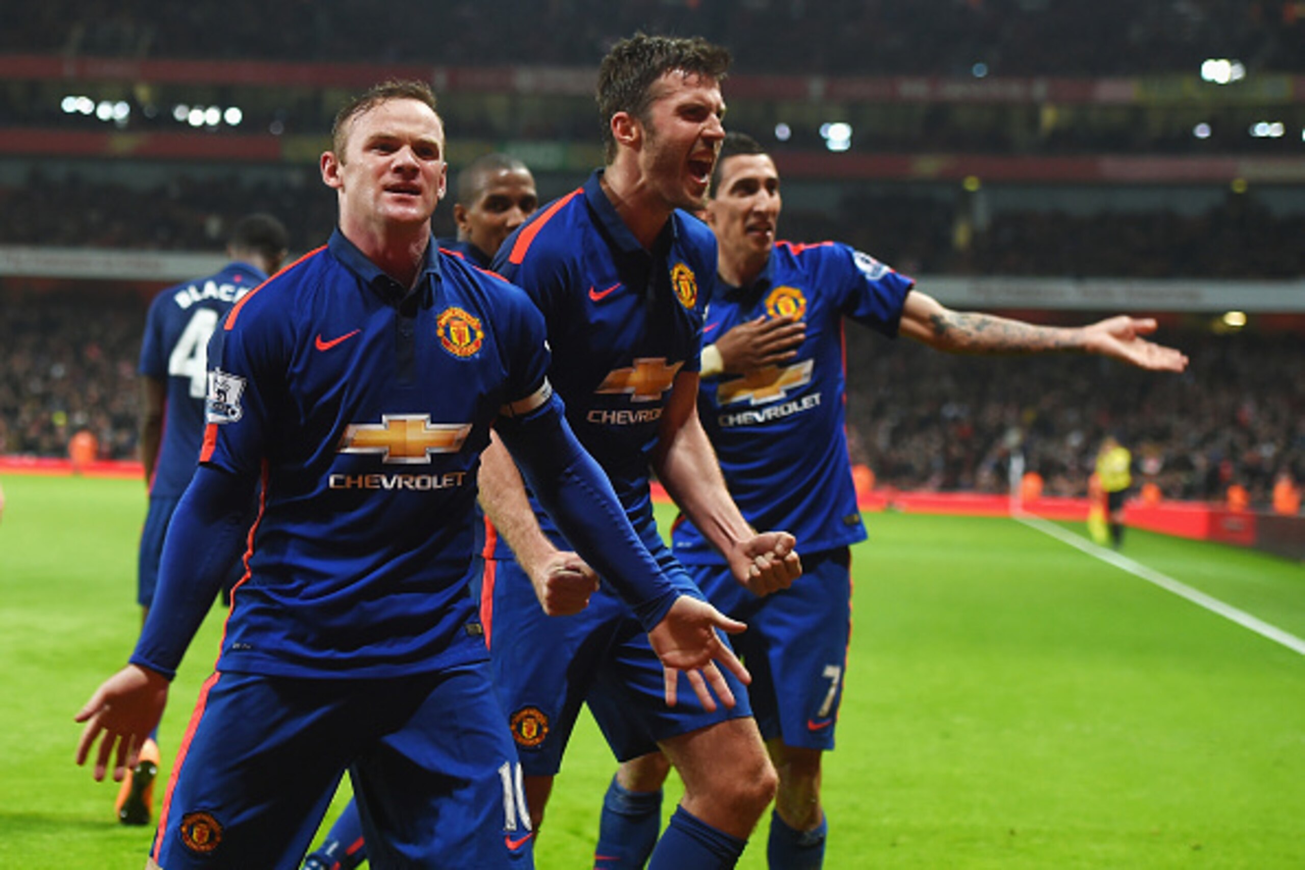 LONDON, ENGLAND - NOVEMBER 22:  Wayne Rooney of Manchester United celebrates scoring his team's second goal with Michael Carrick and Angel Di Maria during the Barclays Premier League match between Arsenal and Manchester United at Emirates Stadium on Novem