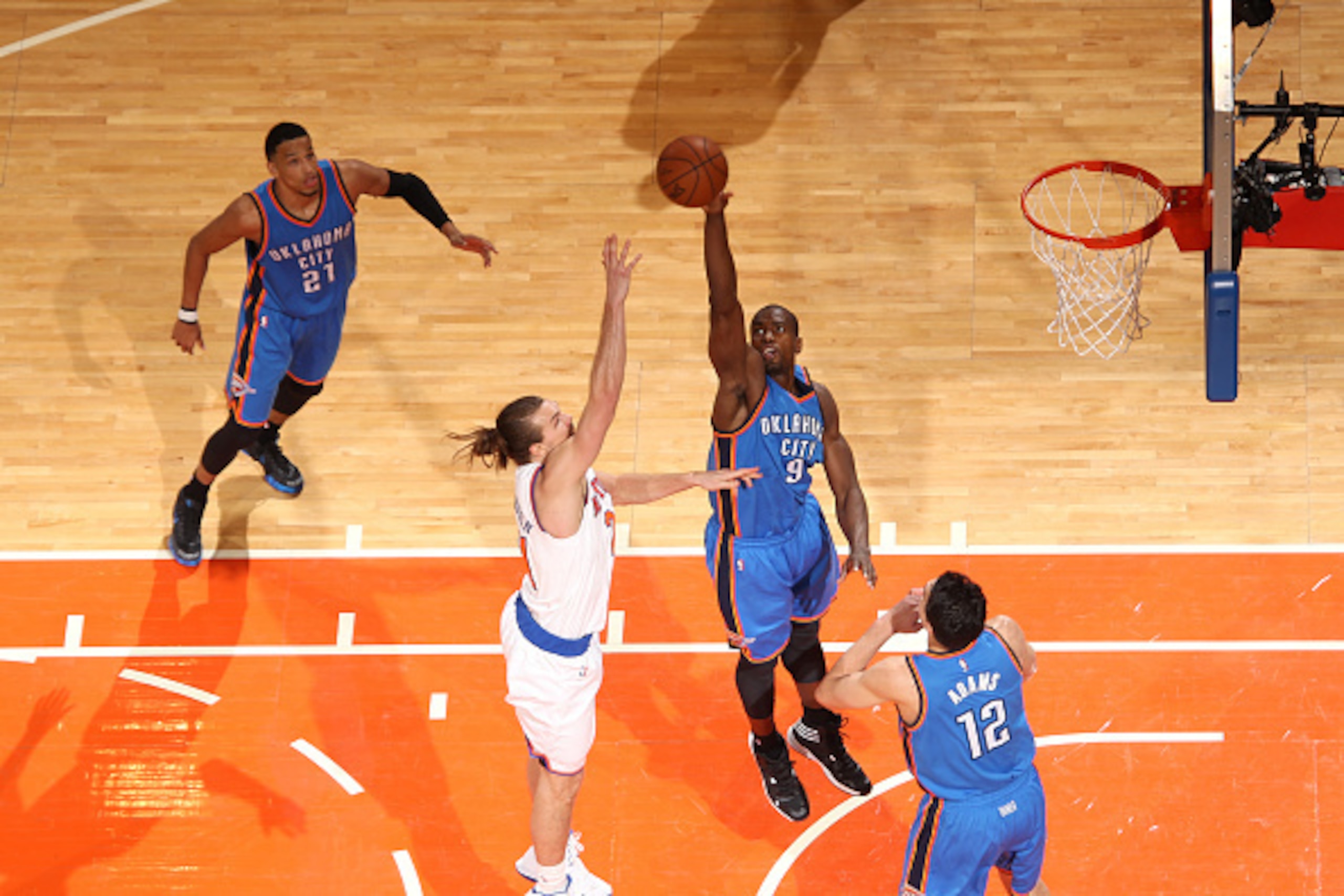 NEW YORK, NY - JANUARY 28:  Serge Ibaka #9 of the Oklahoma City Thunder blocks a shot against Lou Amundson #21 of the New York Knicks on January 28, 2015 at Madison Square Garden in New York City, New York.  NOTE TO USER: User expressly acknowledges and a