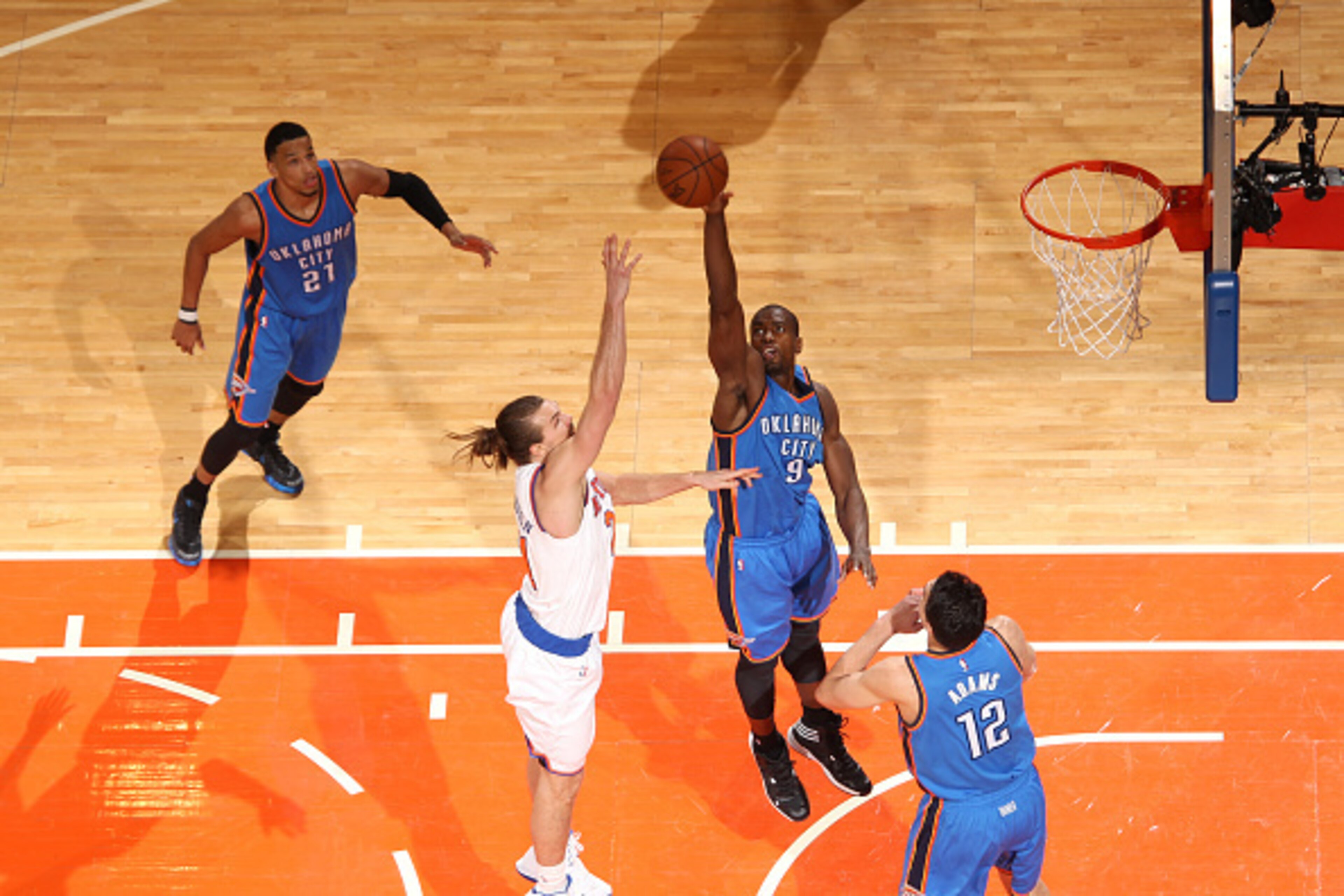 NEW YORK, NY - JANUARY 28:  Serge Ibaka #9 of the Oklahoma City Thunder blocks a shot against Lou Amundson #21 of the New York Knicks on January 28, 2015 at Madison Square Garden in New York City, New York.  NOTE TO USER: User expressly acknowledges and a