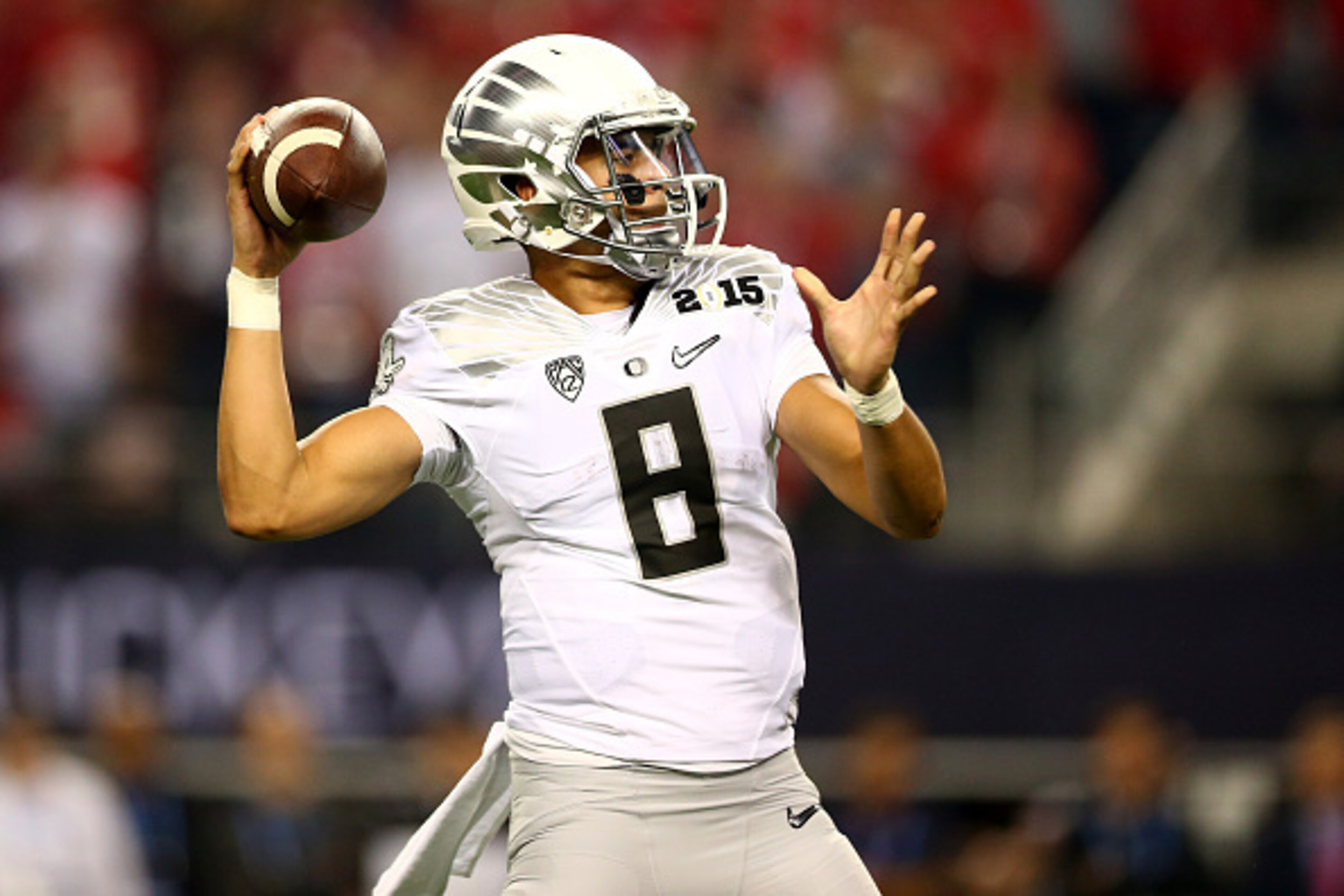 ARLINGTON, TX - JANUARY 12:  Quarterback Marcus Mariota #8 of the Oregon Ducks throws the ball against the Ohio State Buckeyes during the College Football Playoff National Championship Game at AT&T Stadium on January 12, 2015 in Arlington, Texas.  (Photo 