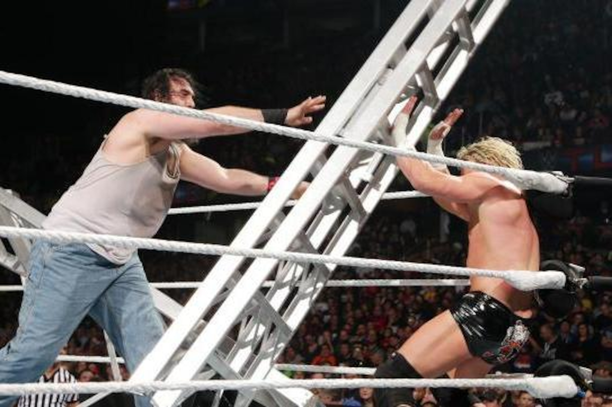 Luke Harper attacks Dolph Ziggler with a ladder.
